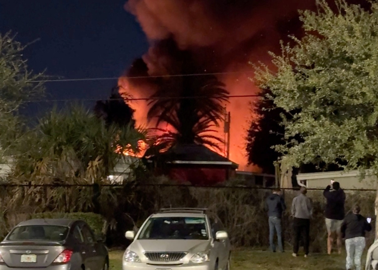 A plume of smoke rises after a small plane crashes in a trailer park in Clearwater, Florida, U.S., February 1, 2024, in this screen grab obtained from a social media video. Steven Ascari