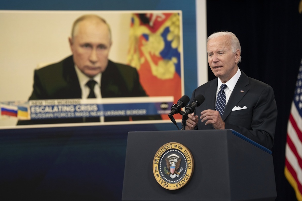 epa10028343 An image of Russian President Vladimir Putin (L) is shown as US President Joe Biden makes remarks on gas prices in the South Court Auditorium of the White House Complex in Washington, DC, USA, 22 June 2022.  EPA