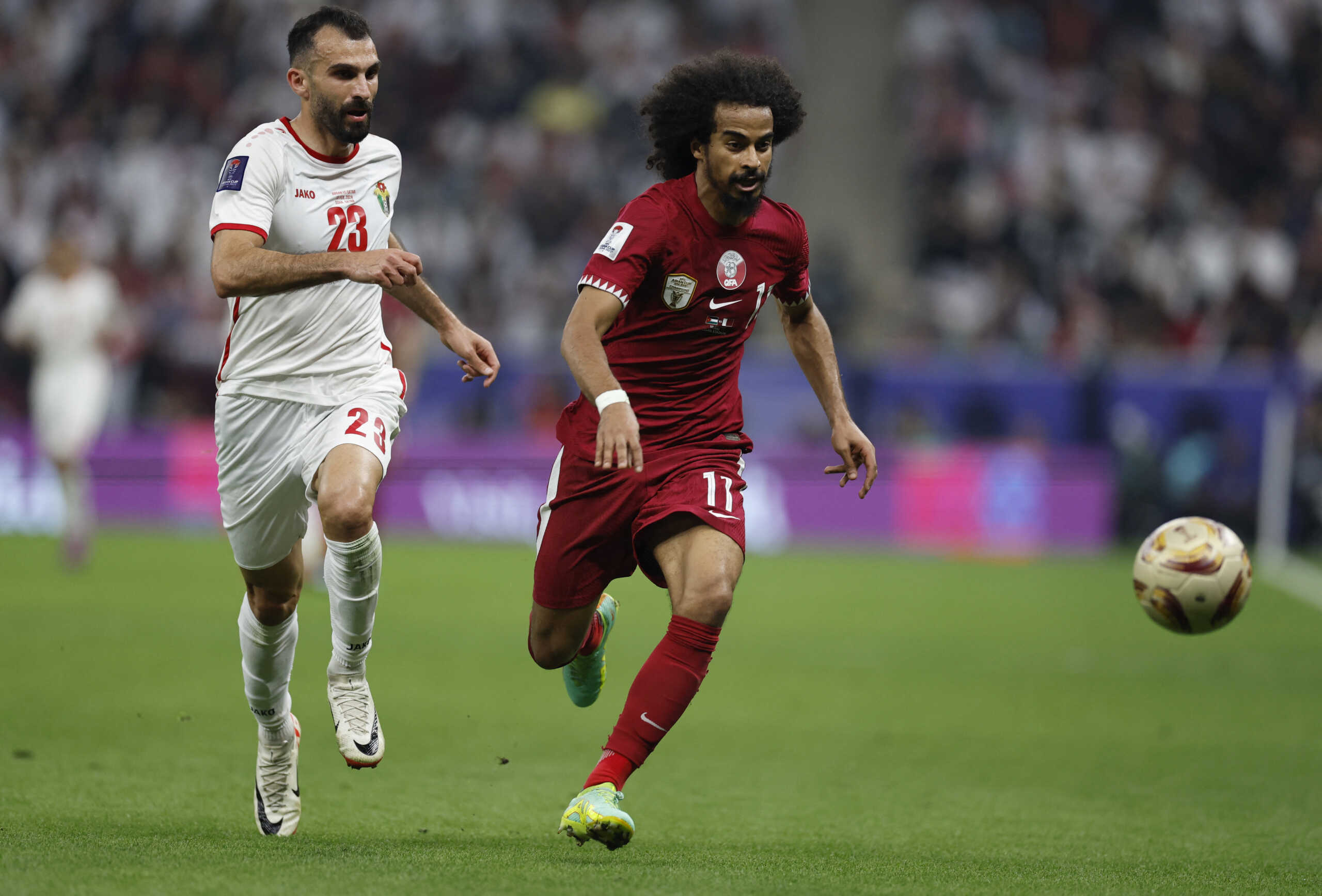 Soccer Football - AFC Asian Cup - Final - Jordan v Qatar - Lusail Stadium, Lusail, Qatar - February 10, 2024 Qatar's Akram Afif in action with Jordan's Ehsan Haddad REUTERS