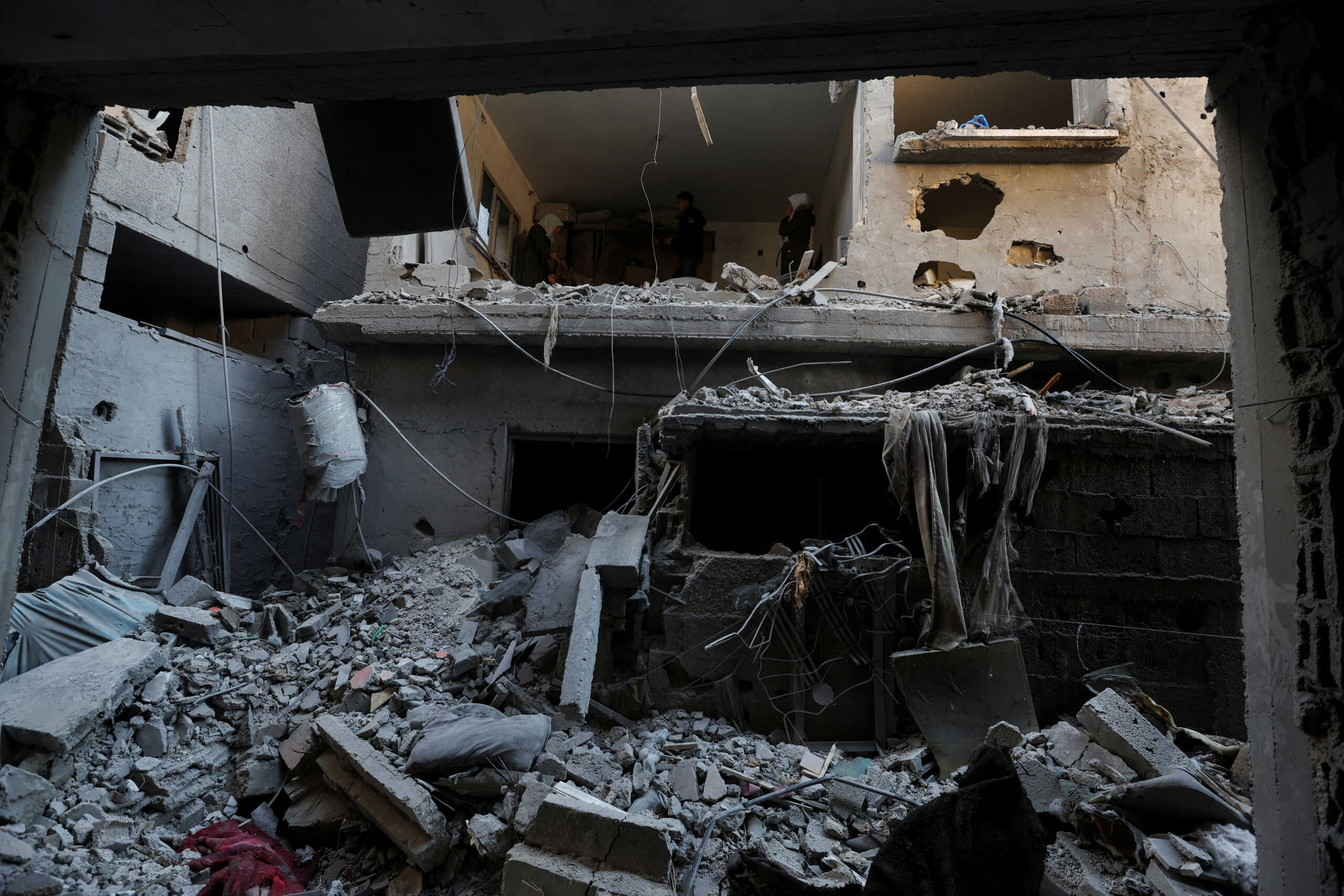 Palestinians inspect the site of an Israeli strike on a house, amid the ongoing conflict between Israel and the Palestinian Islamist group Hamas, in Rafah in the southern Gaza Strip, February 8, 2024. REUTERS
