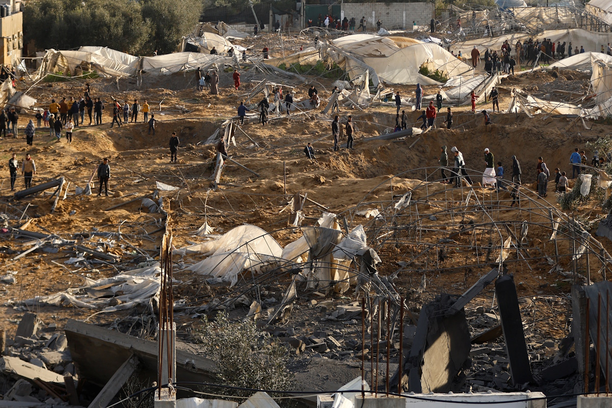 Palestinians inspect the site of an Israeli strike on a house, amid the ongoing conflict between Israel and the Palestinian Islamist group Hamas, in Rafah in the southern Gaza Strip, February 12, 2024. REUTERS