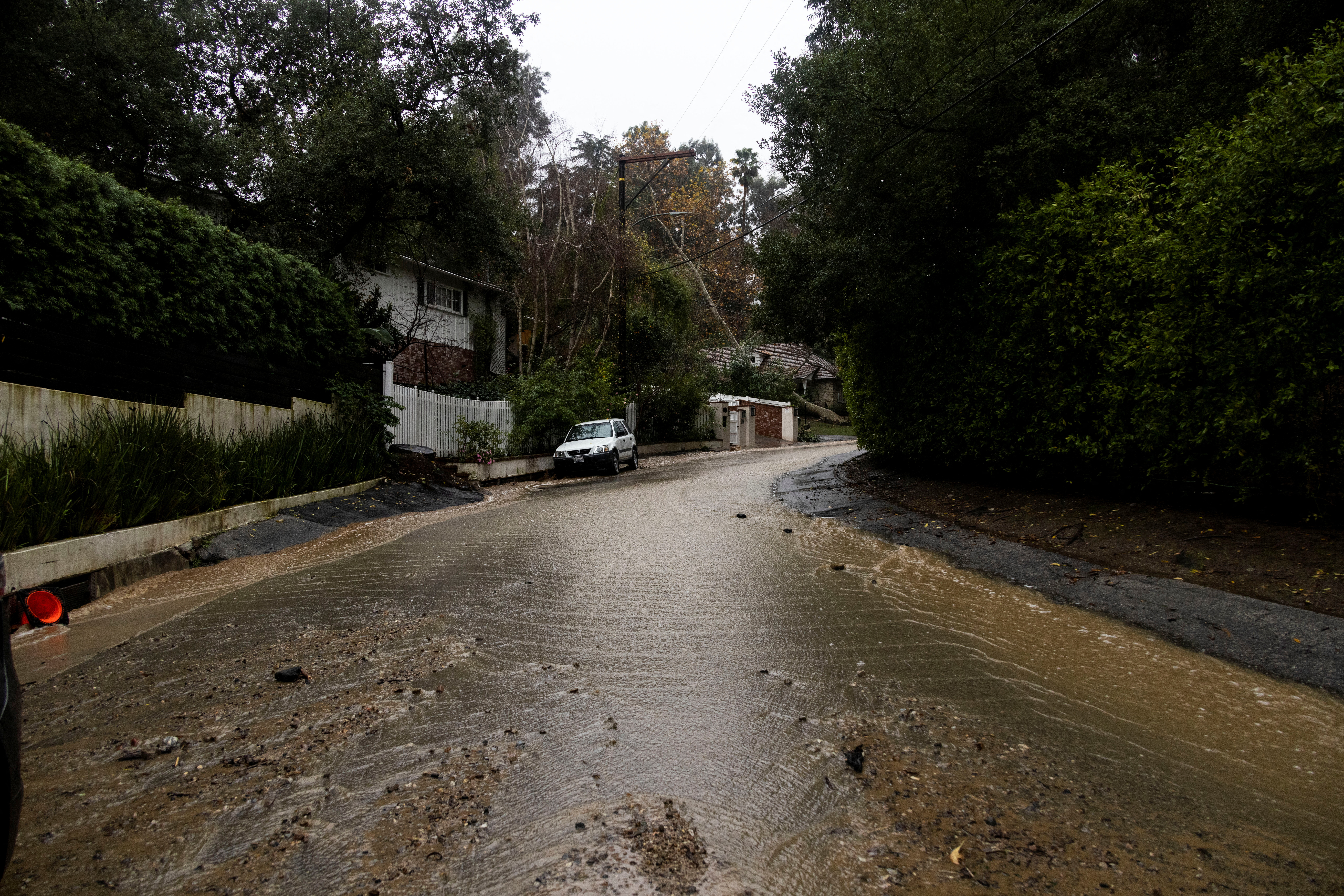 Water and mud run through a street during a rain storm in Studio City, California, U.S., February 5, 2024.  REUTERS