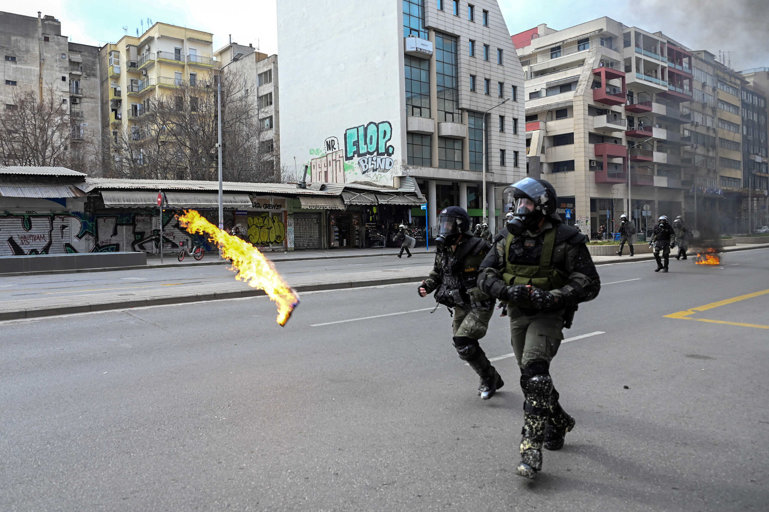 A petrol bomb is thrown at riot police during a demonstration marking a year from Greece’s deadliest train crash, in Thessaloniki, Greece, February 28, 2024. REUTERS