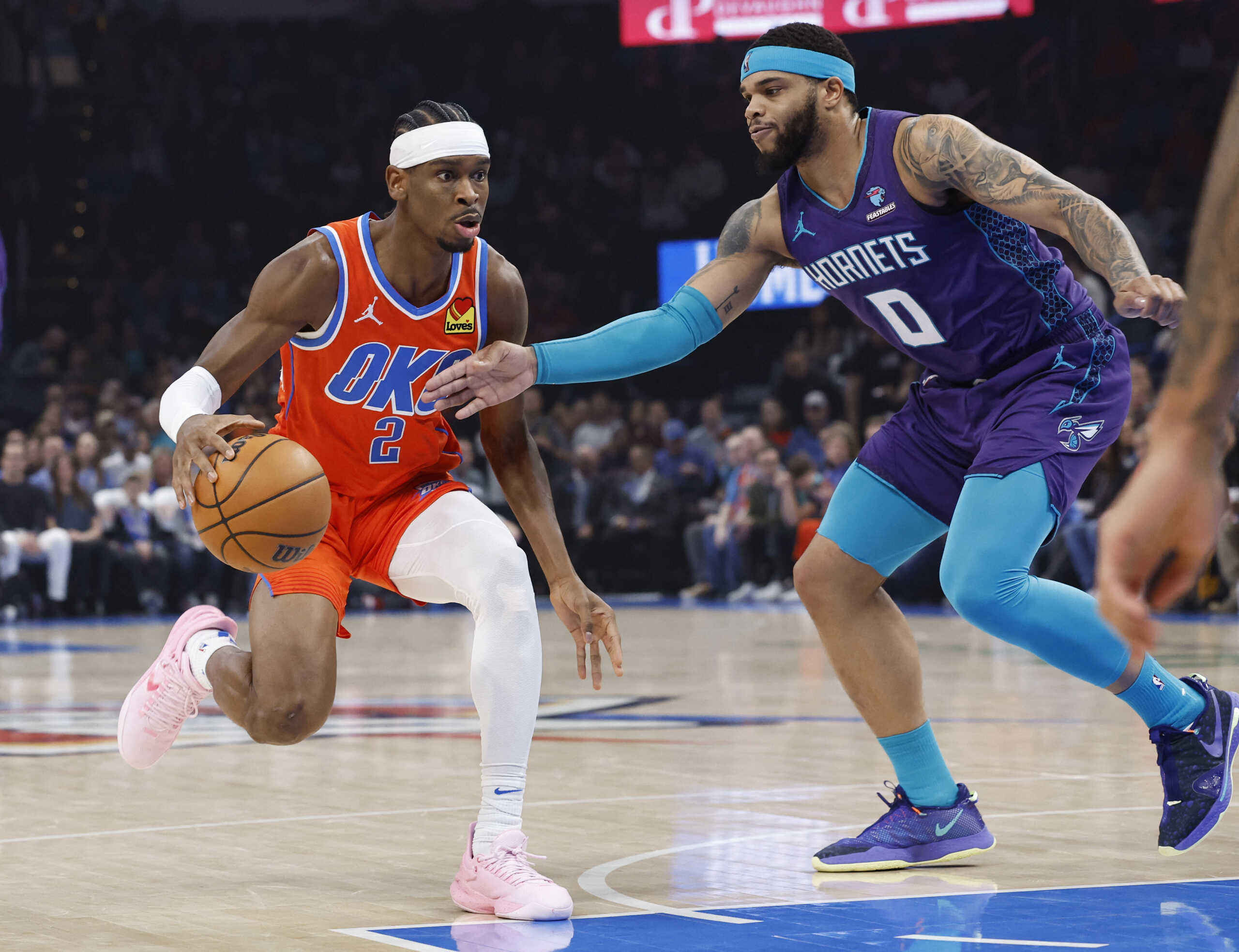 Feb 2, 2024; Oklahoma City, Oklahoma, USA; Oklahoma City Thunder guard Shai Gilgeous-Alexander (2) drives to the basket as Charlotte Hornets forward Miles Bridges (0) defends during the first quarter at Paycom Center. Mandatory Credit: Alonzo Adams-USA TODAY Sports