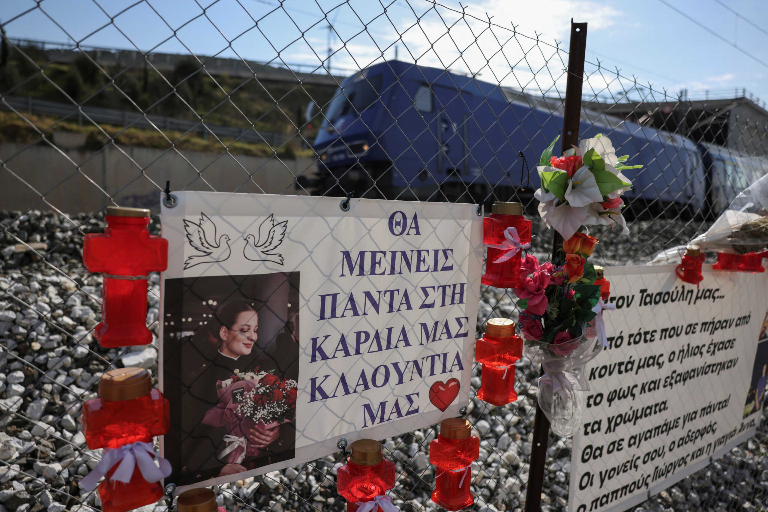 Photos of victims and banners hang at the site of Greece's deadliest train crash, in Tempi, Greece, February 24, 2024. The banner reads "Our Claudia, you will always be in our hearts". REUTERS