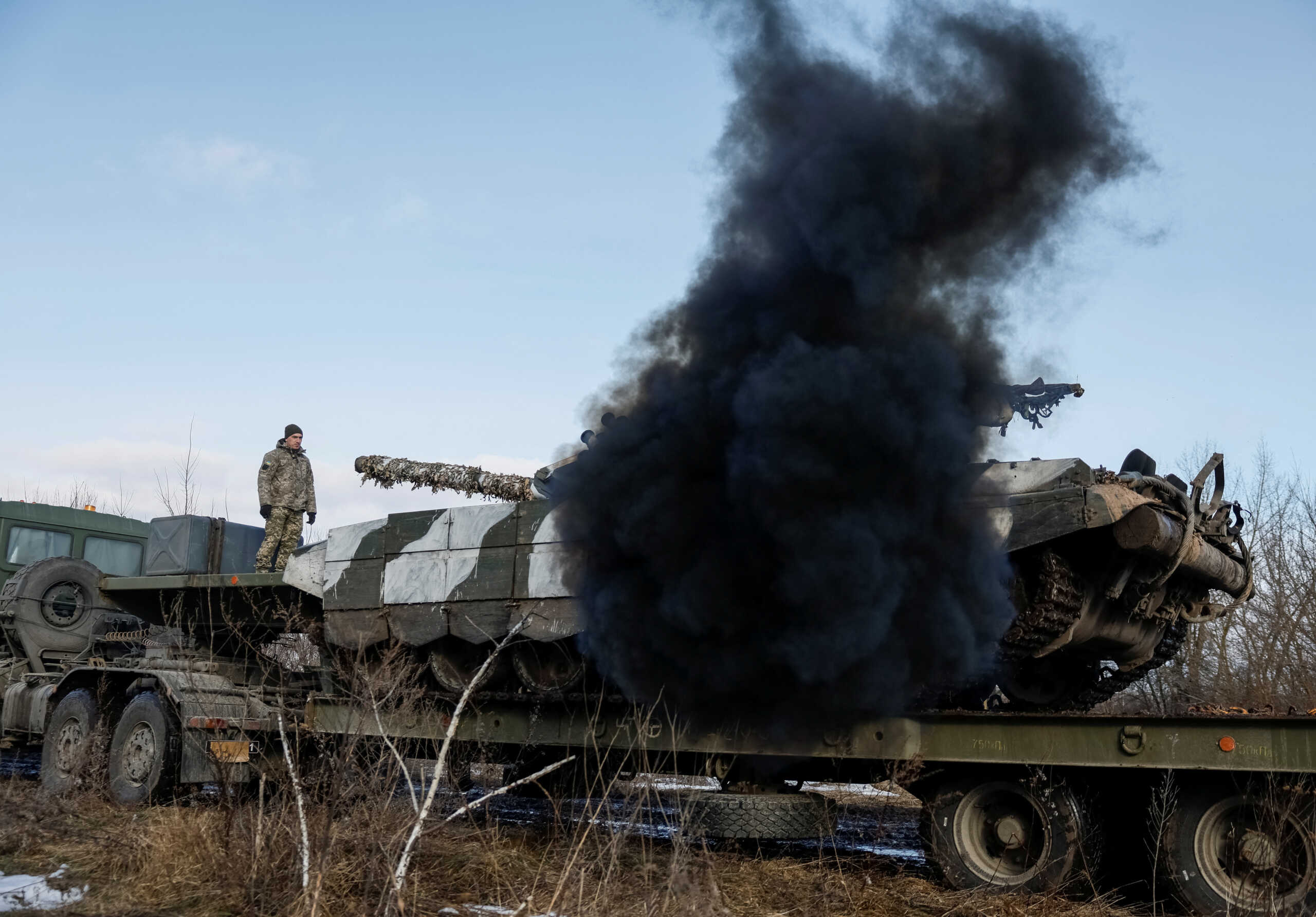 A Ukrainian tank starts engine while being unloaded for repairs, amid Russia's attack on Ukraine, in northern Ukraine February 8, 2024. REUTERS