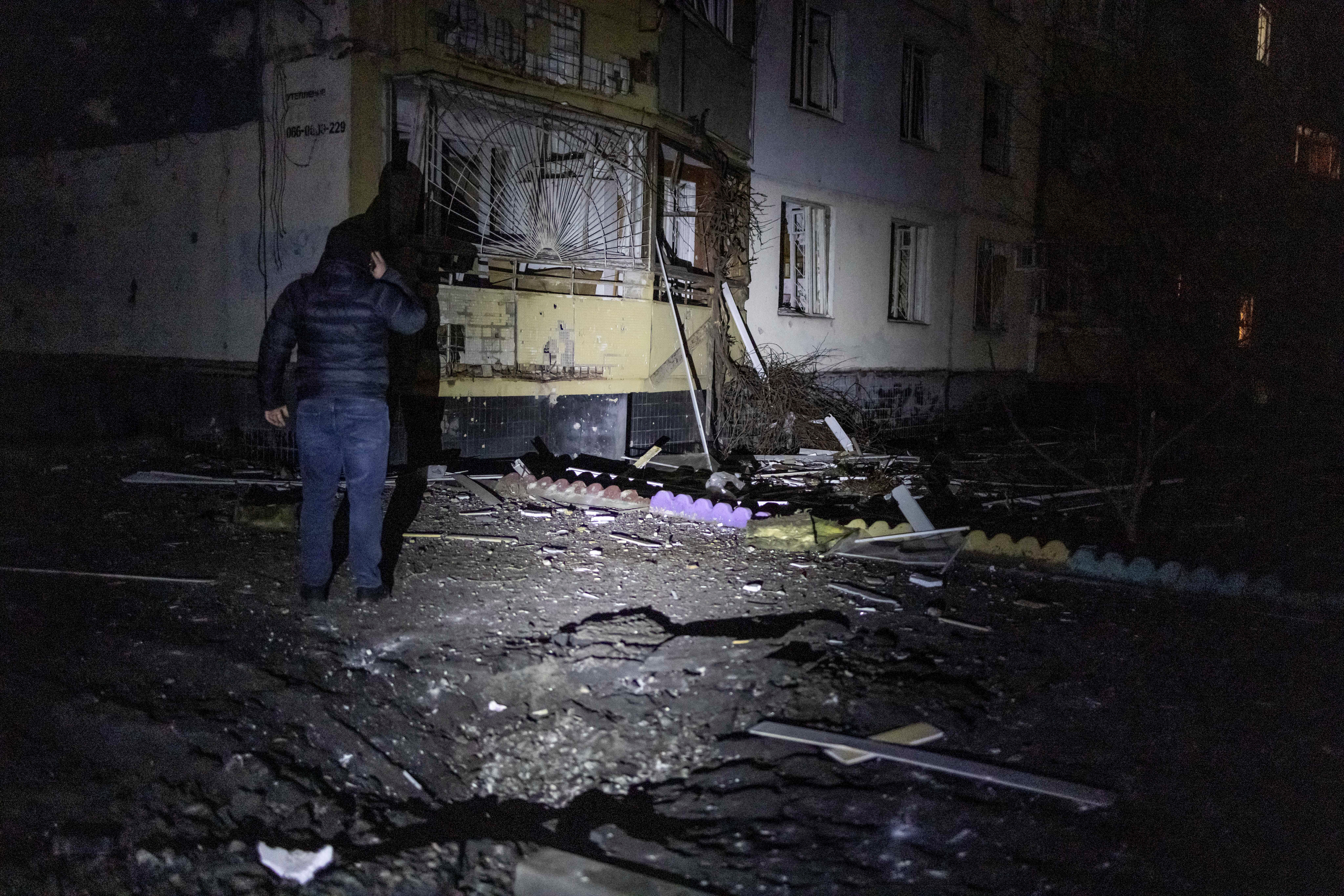 A local resident stands next to an apartment building damaged during a Russian drone strike, amid Russia's attack on Ukraine, in Kharkiv, Ukraine January 31, 2024. REUTERS
