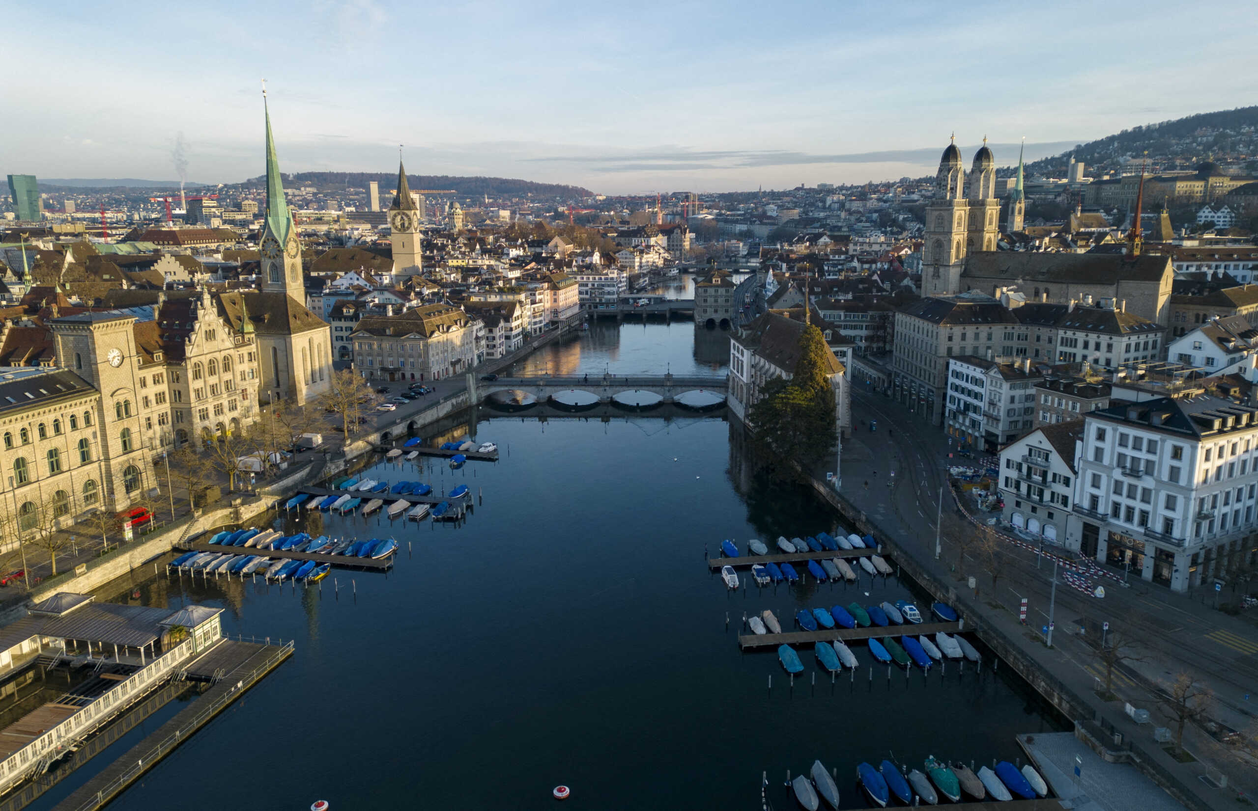 FILE PHOTO: The Limmat river, the Grossmuenster and the city are seen early morning in Zurich, Switzerland March 21, 2023. REUTERS