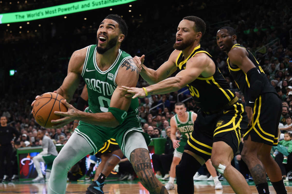 Mar 3, 2024; Boston, Massachusetts, USA;  Boston Celtics forward Jayson Tatum (0) controls the ball while Golden State Warriors guard Stephen Curry (30) defends during the first half at TD Garden. Mandatory Credit: Bob DeChiara-USA TODAY Sports