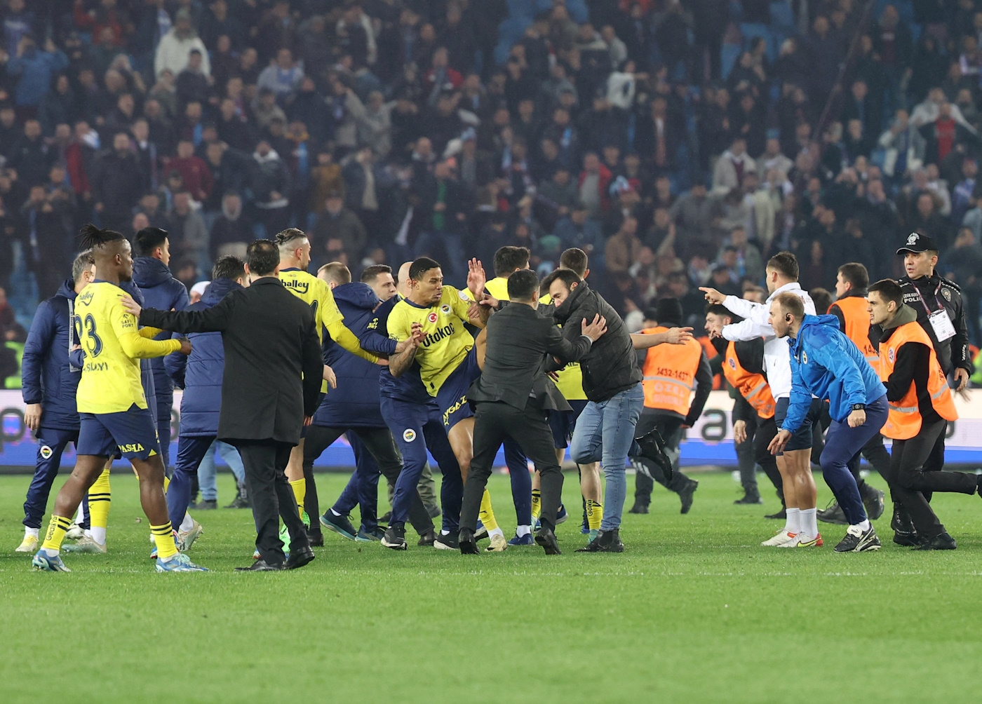 Soccer Football - Super Lig - Trabzonspor v Fenerbahce - Papara Park, Trabzon, Turkey - March 17, 2024 Trabzonspor fans invade the pitch and clash with Fenerbahce players and security staff after the match. REUTERS