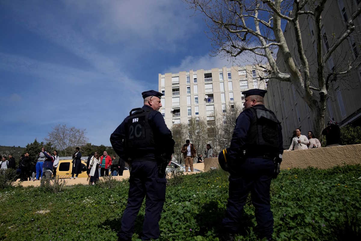 Police officers secure area as French Interior Minister Gerald Darmanin and President Emmanuel Macron take part in a visit focusing on security and the fight against drug trafficking, in La Castellane district of Marseille, southern France March 19, 2024.     Christophe Ena