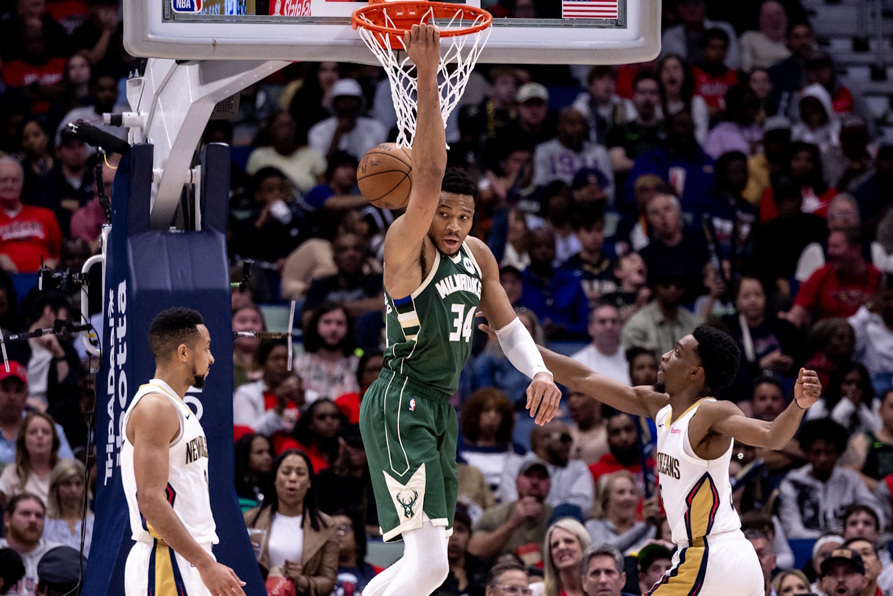 Mar 28, 2024; New Orleans, Louisiana, USA;  Milwaukee Bucks forward Giannis Antetokounmpo (34) dunks the ball against New Orleans Pelicans guard CJ McCollum (3) and forward Herbert Jones (5) during the second half at Smoothie King Center. Mandatory Credit: Stephen Lew-USA TODAY Sports