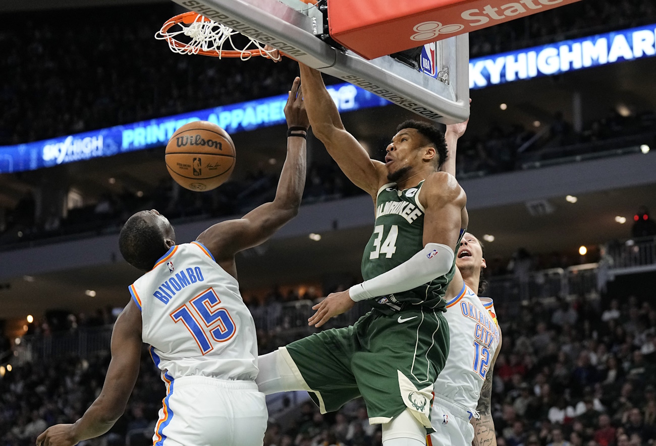 Mar 24, 2024; Milwaukee, Wisconsin, USA;  Milwaukee Bucks forward Giannis Antetokounmpo (34) dunks over Oklahoma City Thunder center Bismack Biyombo (15) during the fourth quarter at Fiserv Forum. Mandatory Credit: Jeff Hanisch-USA TODAY Sports