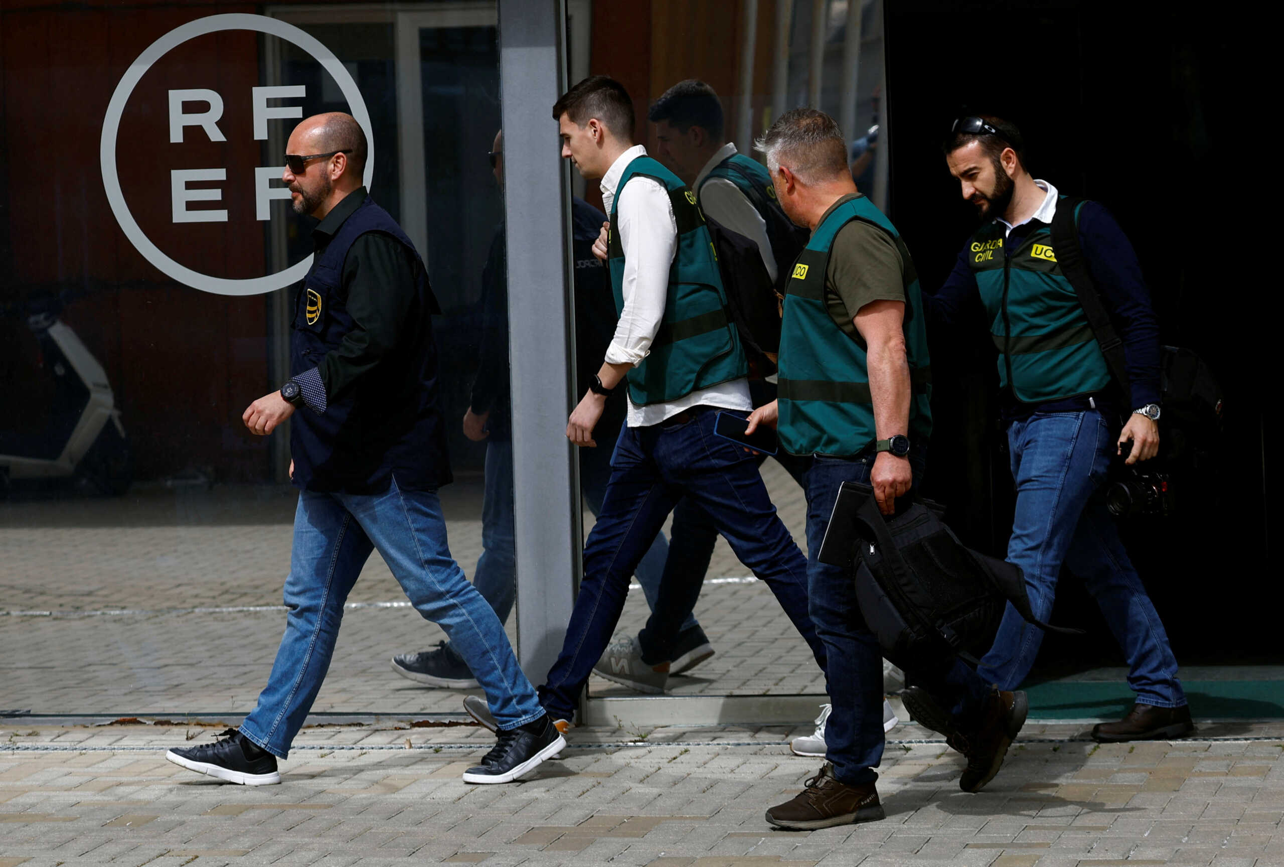 Three Spanish Civil Guards and one Europol officer walk out of the soccer federation headquarters as they search evidence in corruption probe, in Las Rozas, Spain March 20, 2024. REUTERS