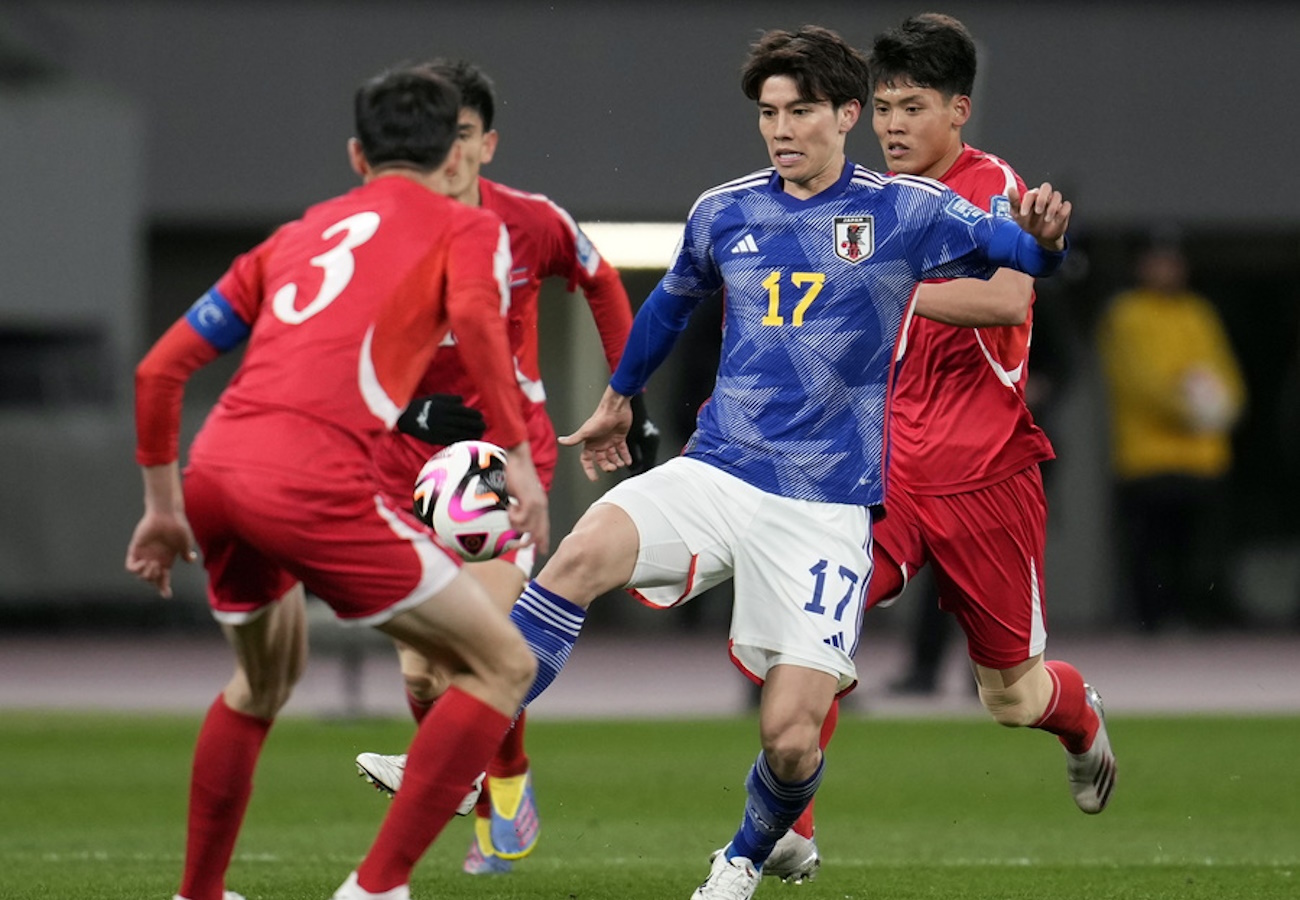 epa11233774 Ao Tanaka (R) of Japan in action against Jang Kuk-chol of North Korea  during the FIFA World Cup 2026 qualification match between North Korea and Japan at the National Stadium in Tokyo, Japan, 21 March 2024.  EPA