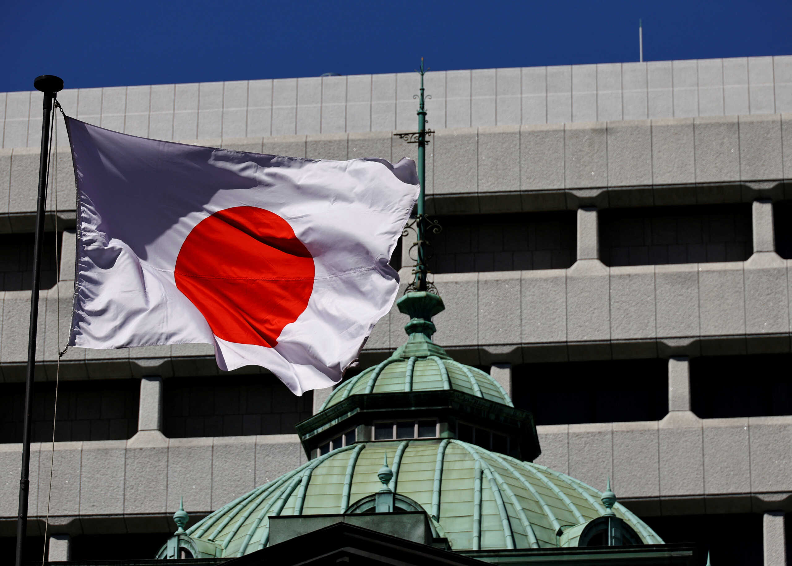 The Japanese national flag waves at the Bank of Japan building in Tokyo, Japan March 18, 2024. REUTERS