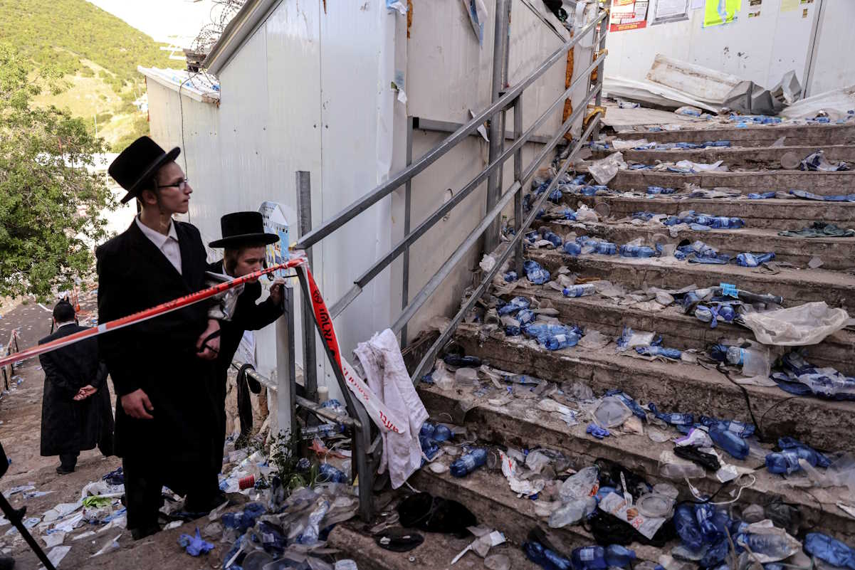 FILE PHOTO: Ultra Orthodox Jews look at stairs with waste on it in Mount Meron, northern Israel, where fatalities were reported among the thousands of ultra-Orthodox Jews gathered at the tomb of a 2nd-century sage for annual commemorations that include all-night prayer and dance, April 30, 2021. REUTERS