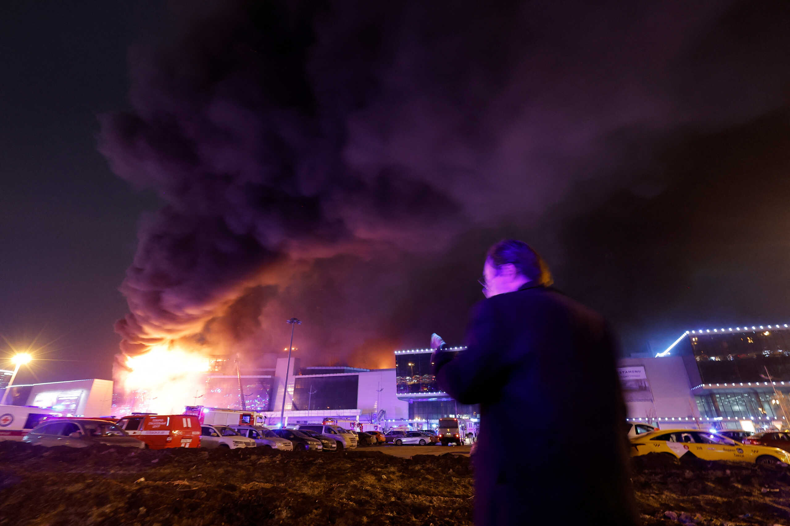 Smoke from fire rises above the burning Crocus City Hall concert venue following a shooting incident, outside Moscow, Russia, March 22, 2024. REUTERS