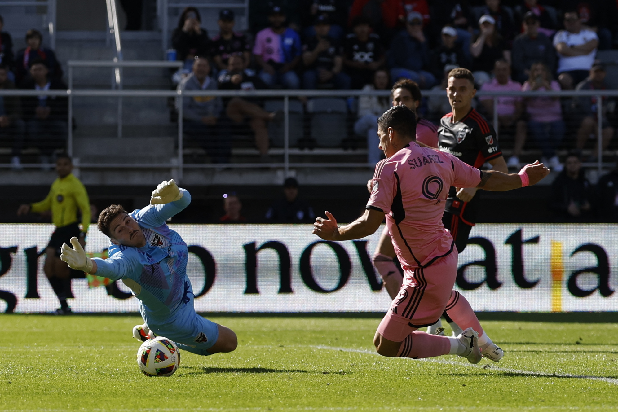 Mar 16, 2024; Washington, District of Columbia, USA; Inter Miami CF forward Luis Suarez (9) scores a goal against D.C. United goalkeeper Alex Bono (24) during the second half at Audi Field. Mandatory Credit: Geoff Burke-USA TODAY Sports