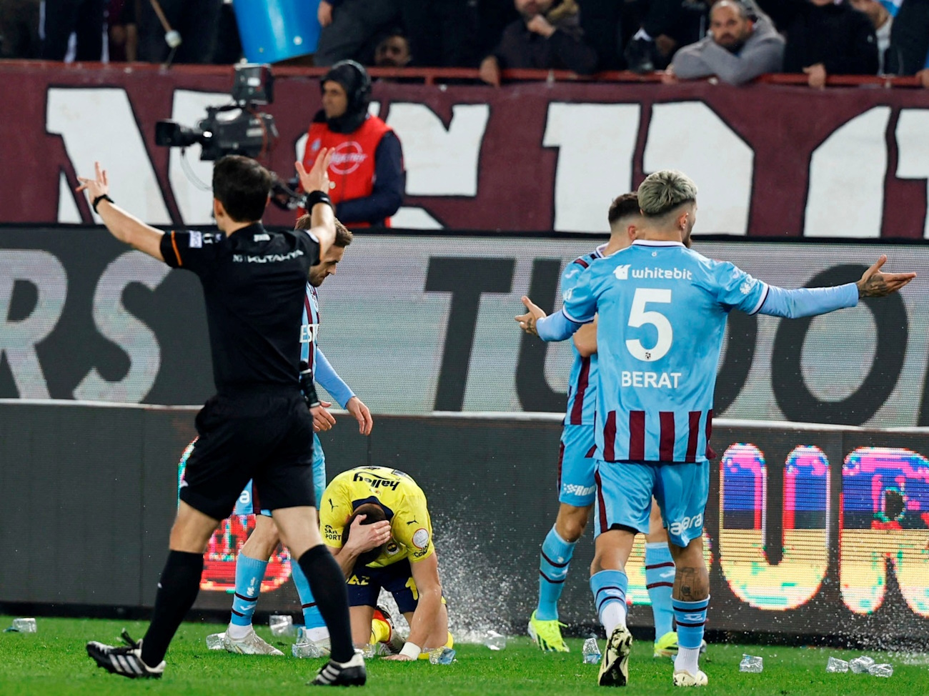Soccer Football - Super Lig - Trabzonspor v Fenerbahce - Papara Park, Trabzon, Turkey - March 17, 2024 Fenerbahce's Dusan Tadic holds his head after he was hit by an object thrown by Trabzonspor fans. Fenerbahce.org