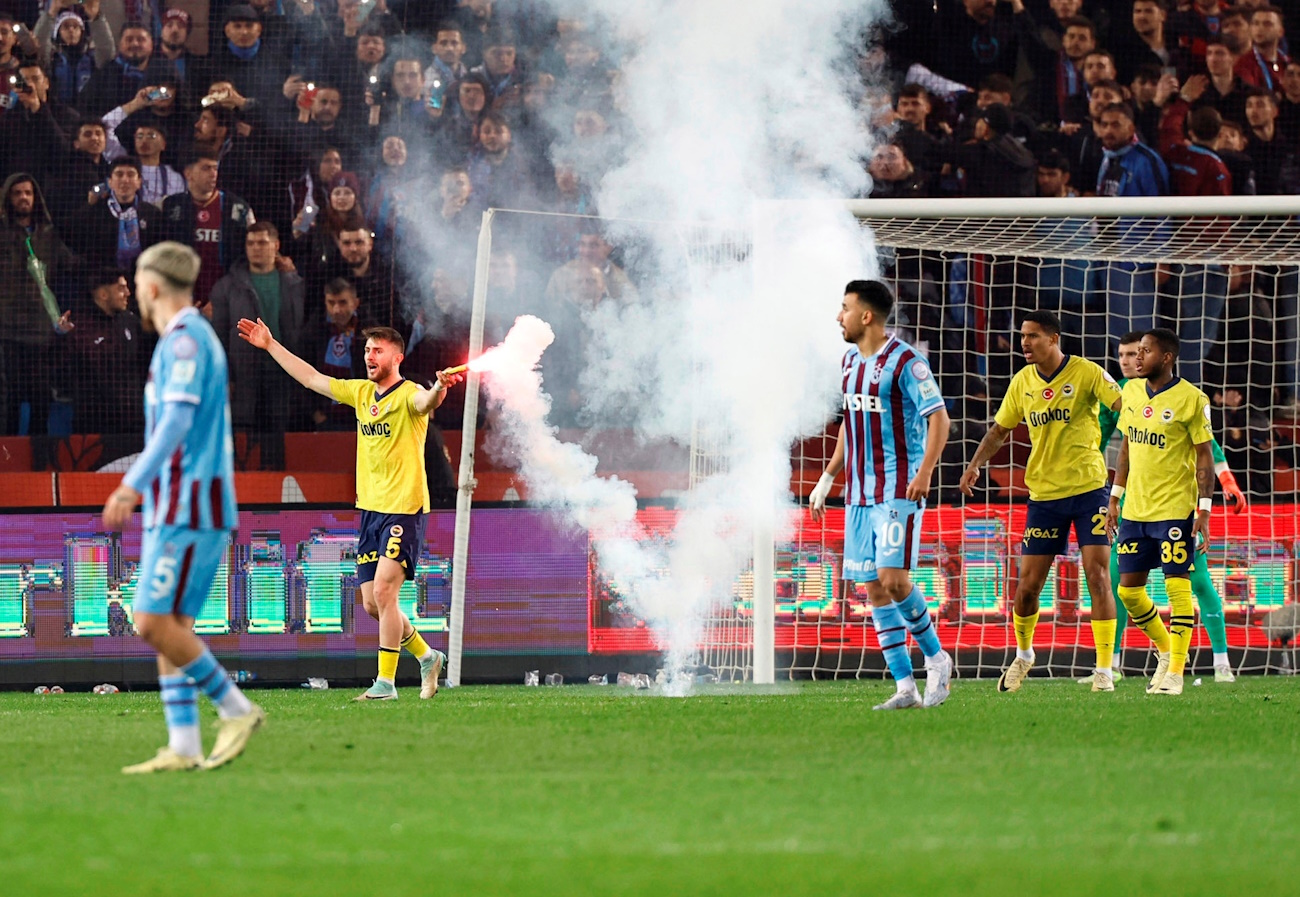 Soccer Football - Super Lig - Trabzonspor v Fenerbahce - Papara Park, Trabzon, Turkey - March 17, 2024 Fenerbahce's Ismail Yuksek holds a flare thrown by Trabzonspor fans. Fenerbahce.org