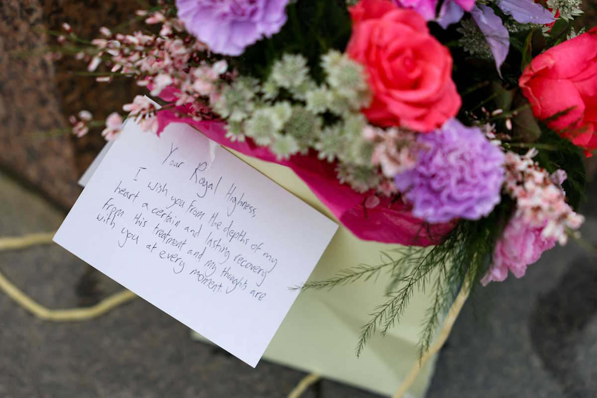 A message for Britain's Catherine, Princess of Wales, is placed on a bouquet of flowers near Windsor Castle, the day after the news that Catherine has revealed she is undergoing preventative chemotherapy after tests taken following abdominal surgery in January revealed cancer had been present, in Windsor, Britain, March 23, 2024. REUTERS