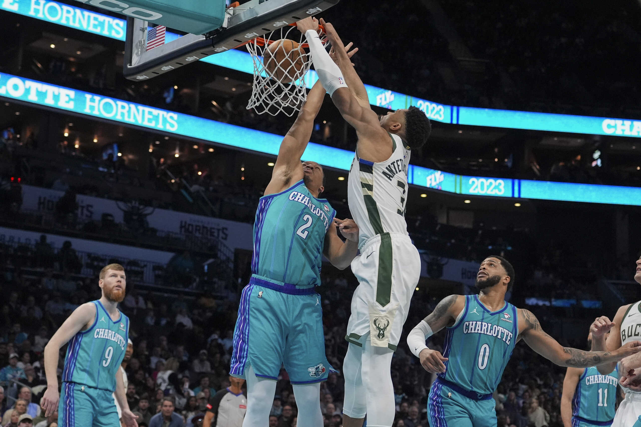 Feb 29, 2024; Charlotte, North Carolina, USA;  Milwaukee Bucks forward Giannis Antetokounmpo (34) gets a dunk defended by Charlotte Hornets forward Grant Williams (2) during the second quarter at Spectrum Center. Mandatory Credit: Jim Dedmon-USA TODAY Sports