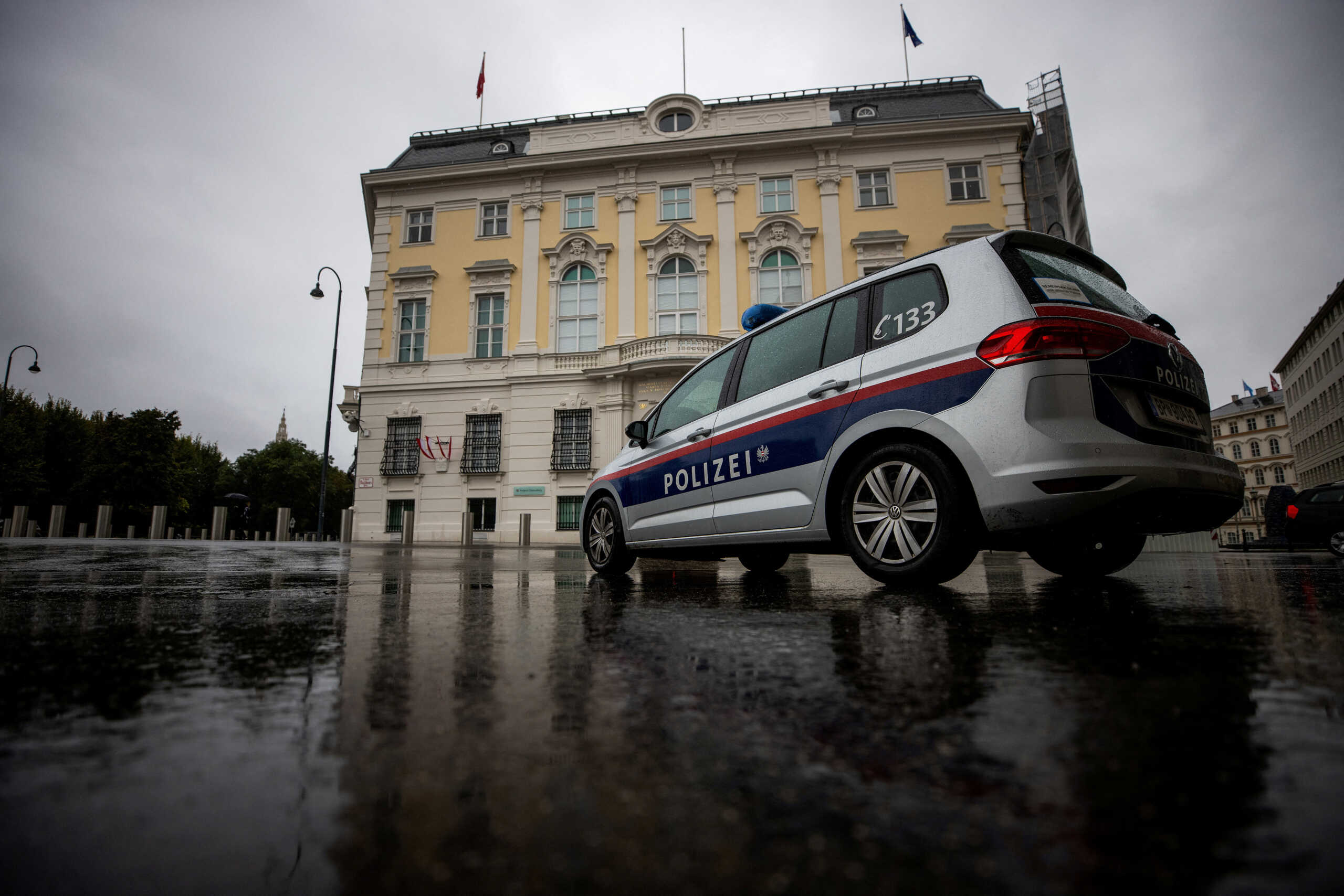 FILE PHOTO: A police car parks in front of the Austrian federal chancellery in Vienna, Austria October 7, 2021. REUTERS
