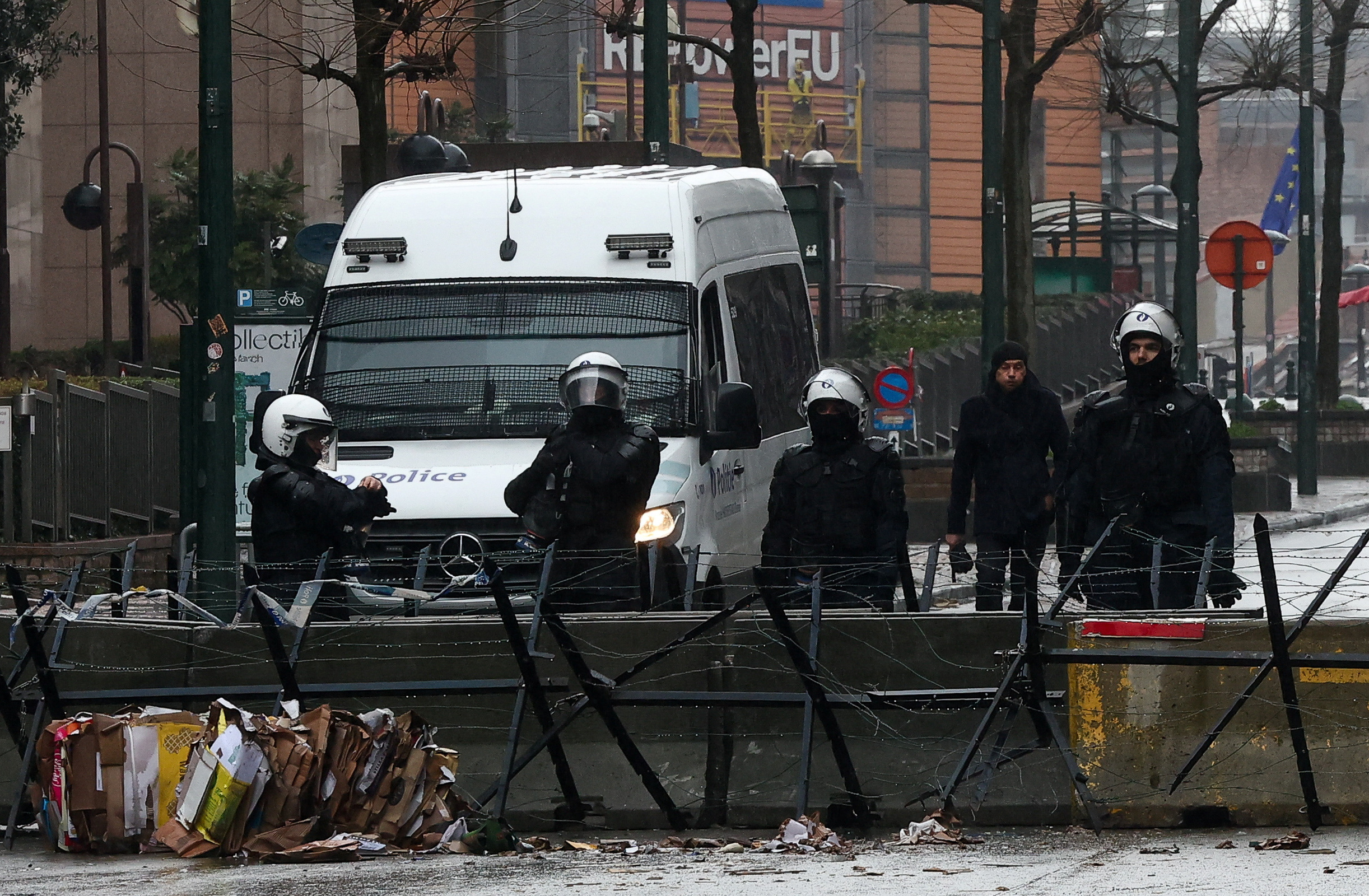 Police officers stand during a protest of European farmers over price pressures, taxes and green regulation, on the day of an EU Agriculture Ministers meeting in Brussels, Belgium February 26, 2024. REUTERS