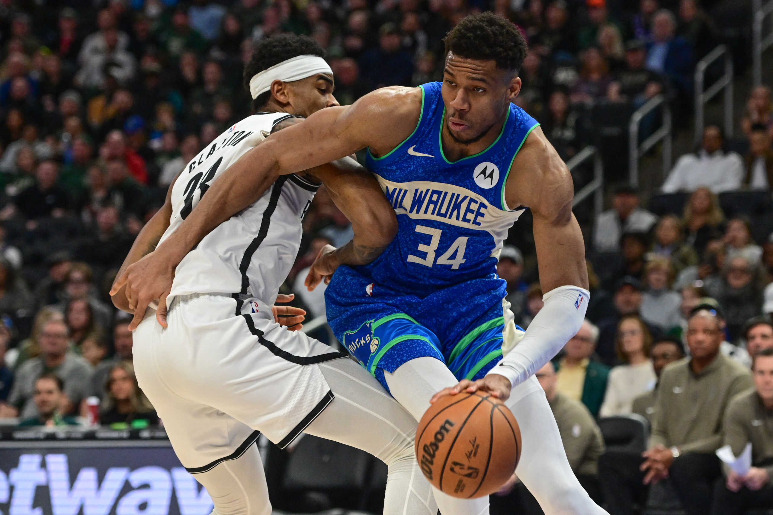 Mar 21, 2024; Milwaukee, Wisconsin, USA;  Milwaukee Bucks forward Giannis Antetokounmpo (34) drives around Brooklyn Nets center Nicolas Claxton (33) in the second quarter at Fiserv Forum. Mandatory Credit: Benny Sieu-USA TODAY Sports