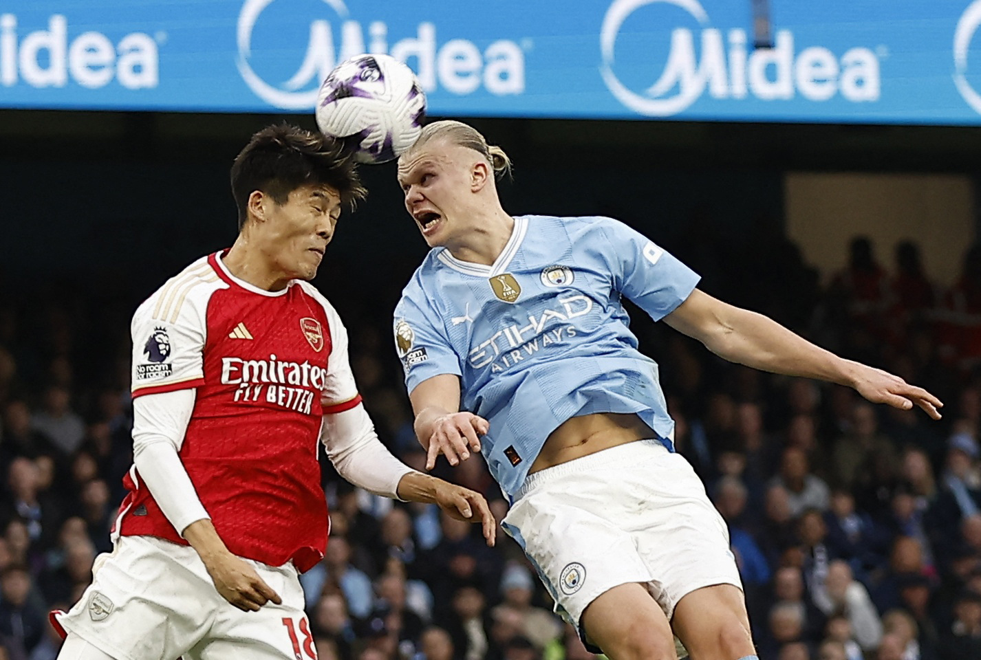 Soccer Football - Premier League - Manchester City v Arsenal - Etihad Stadium, Manchester, Britain - March 31, 2024 Arsenal's Takehiro Tomiyasu in action with Manchester City's Erling Braut Haaland Action Images via Reuters