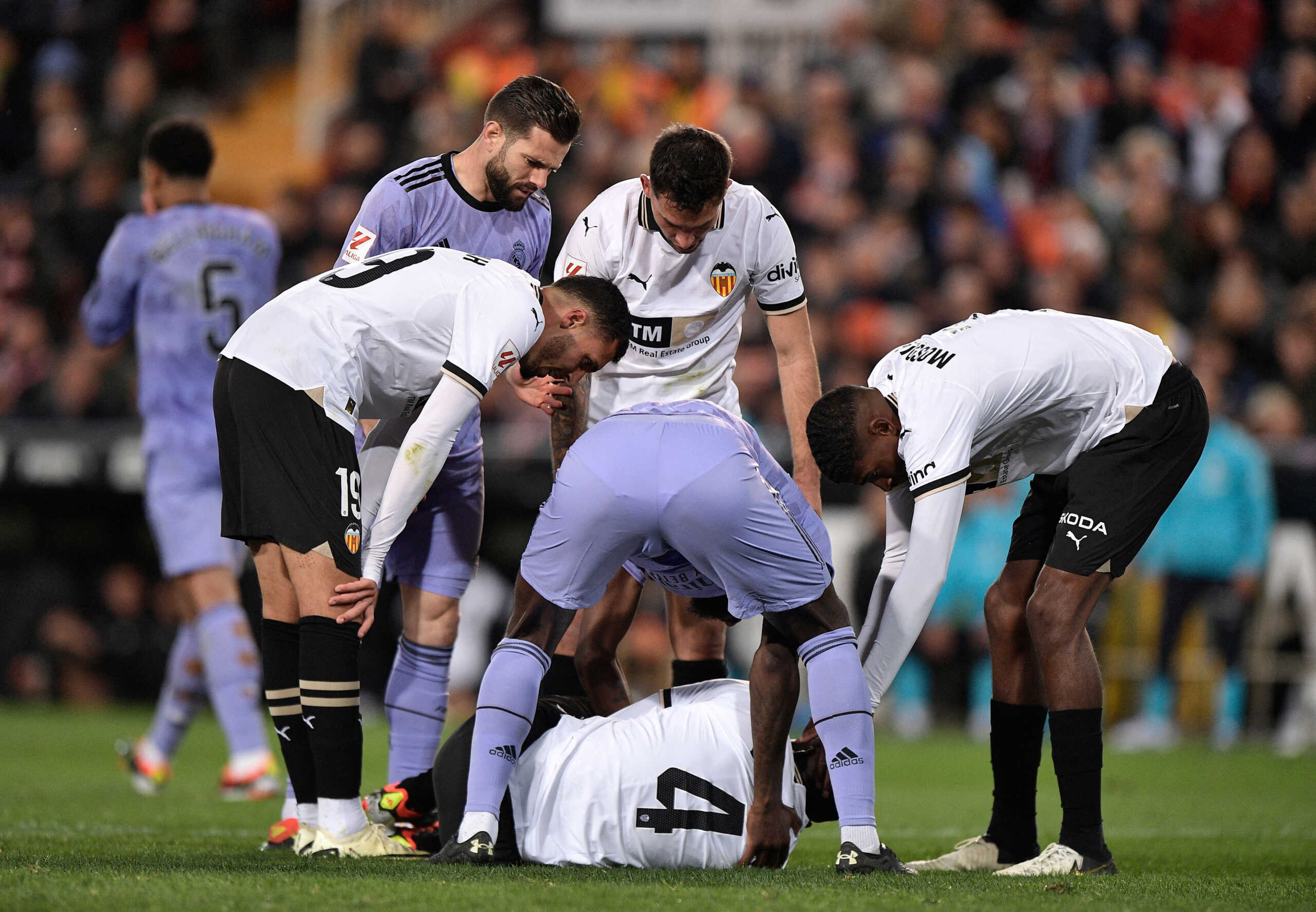Soccer Football - LaLiga - Valencia v Real Madrid - Mestalla, Valencia, Spain - March 2, 2024 Valencia's Mouctar Diakhaby reacts after sustaining an injury as players look on REUTERS