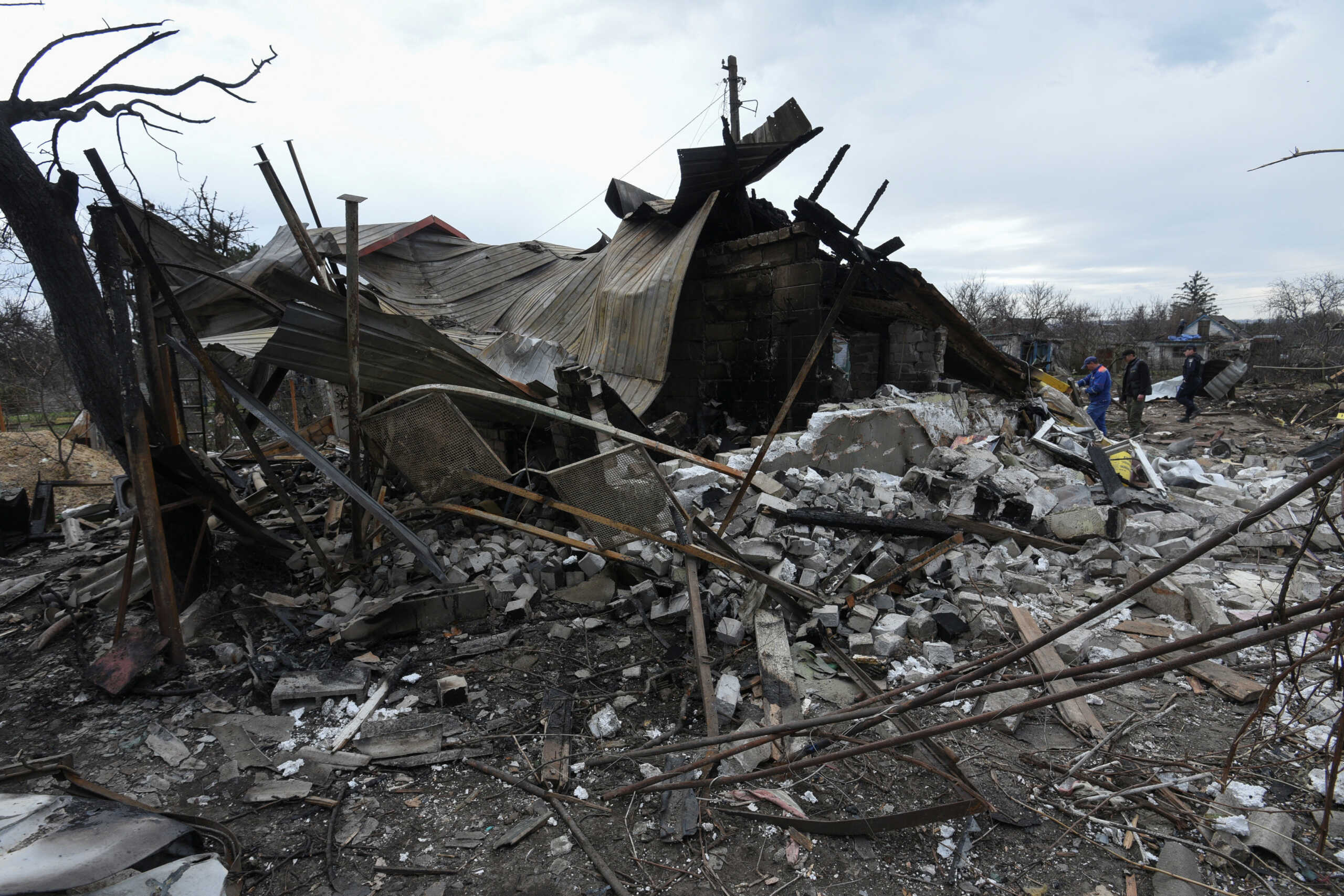 Municipal workers and a police officer inspect remains of a residential building destroyed during a Russian missile and drone strike, amid Russia's attack on Ukraine, in the city of Kamianske, Dnipropetrovsk region, Ukraine March 29, 2024. REUTERS