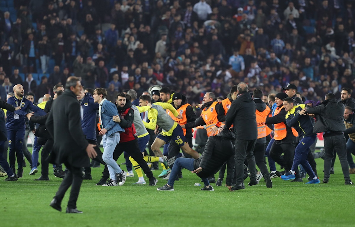epa11226900 Trabzonspor fans attack Fenerbahce players after the Super League match between Trabzonspor and Fenerbahce in Trabzon, Turkey, 17 March 2024. After Fenerbahce won the match 3-2 against Trabzonspor fans entered the field and began chasing away Fenerbahce players.  EPA