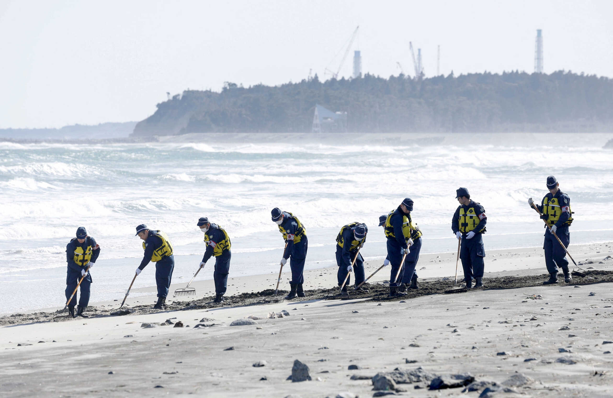 Police officers search the beach for clues about missing persons from the 2011 earthquake and tsunami disaster near the tsunami-crippled Fukushima Daiichi nuclear power plant in Namie-town, Fukushima prefecture, Japan March 11, 2024, on the day marking 13-year anniversary of the disaster, in this photo taken by Kyodo. Mandatory credit Kyodo via REUTERS ATTENTION EDITORS - THIS IMAGE WAS PROVIDED BY A THIRD PARTY. MANDATORY CREDIT. JAPAN OUT. NO COMMERCIAL OR EDITORIAL SALES IN JAPAN