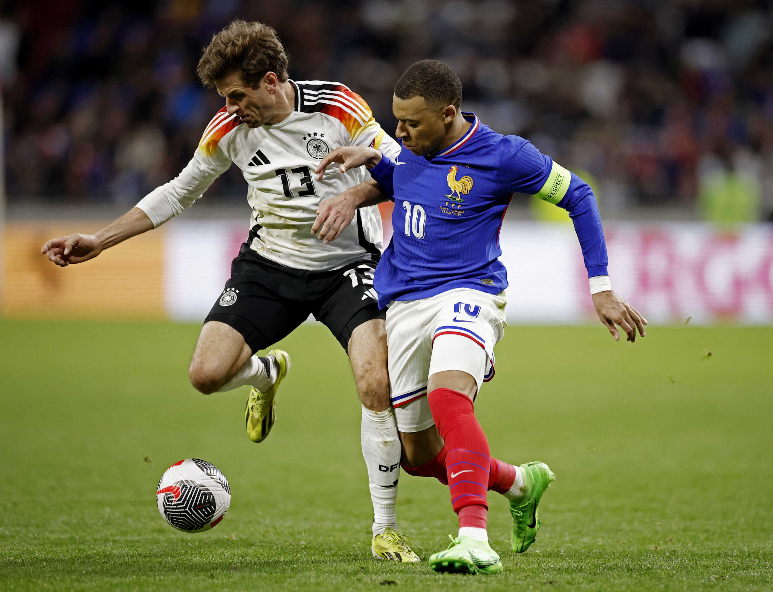 Soccer Football - International Friendly - France v Germany - Groupama Stadium, Lyon, France - March 23, 2024 Germany's Thomas Muller in action with France's Kylian Mbappe REUTERS