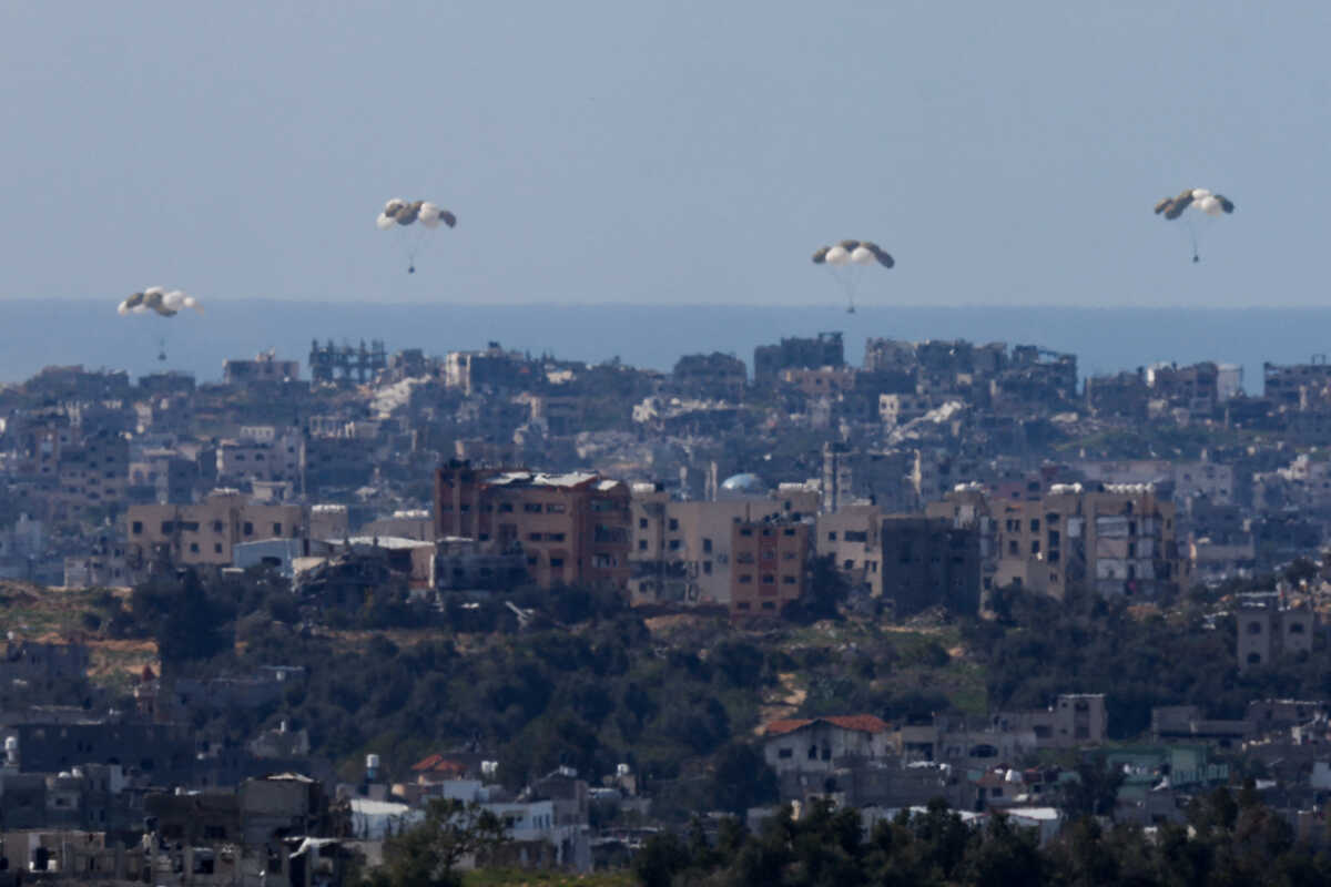 Packages fall towards northern Gaza, after being dropped from a military aircraft, amid the ongoing conflict between Israel and the Palestinian group Hamas, as seen from Israel's border with Gaza, in southern Israel March 9, 2024. REUTERS