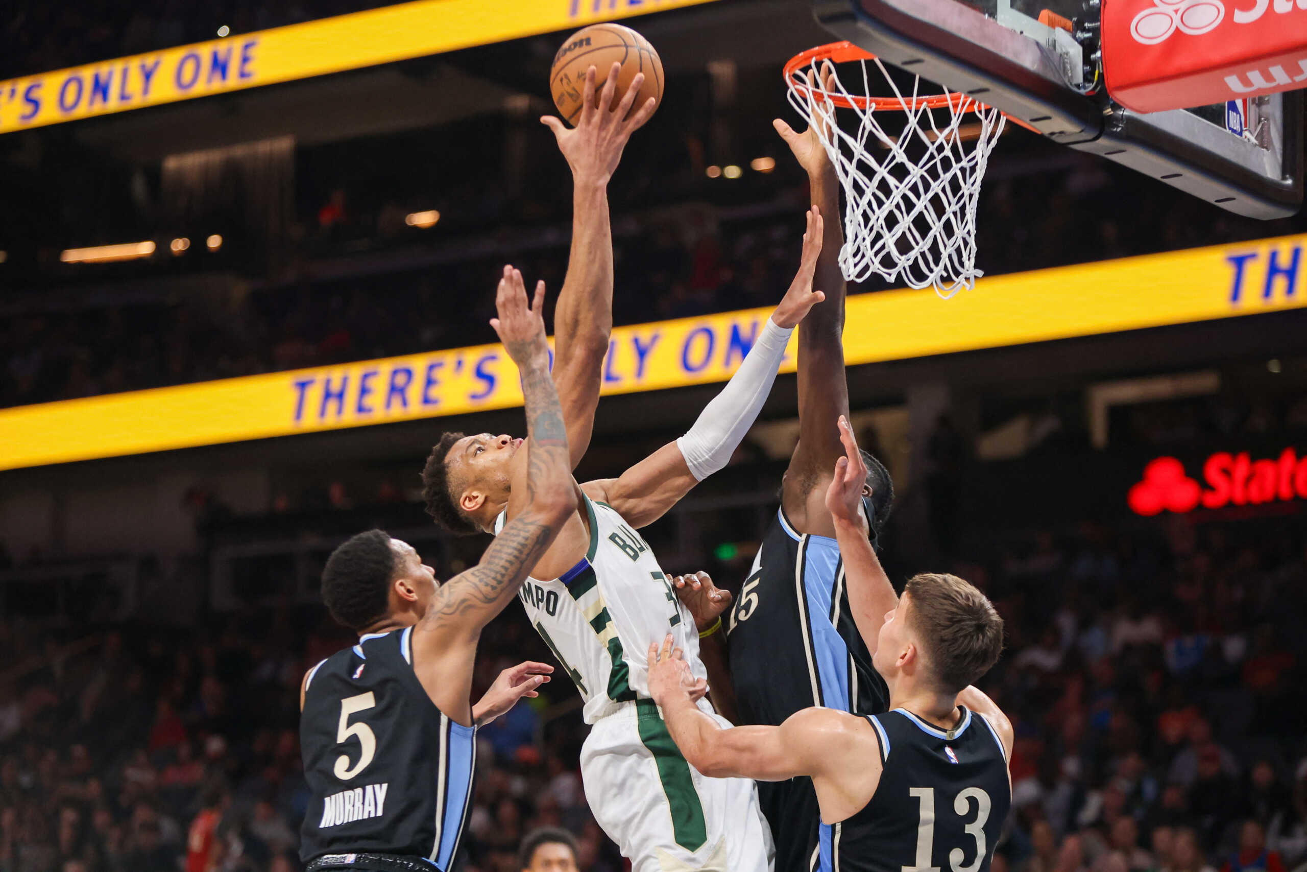 Mar 30, 2024; Atlanta, Georgia, USA; Milwaukee Bucks forward Giannis Antetokounmpo (34) shoots past Atlanta Hawks guard Dejounte Murray (5) and center Clint Capela (15) and guard Bogdan Bogdanovic (13) in the second quarter at State Farm Arena. Mandatory Credit: Brett Davis-USA TODAY Sports