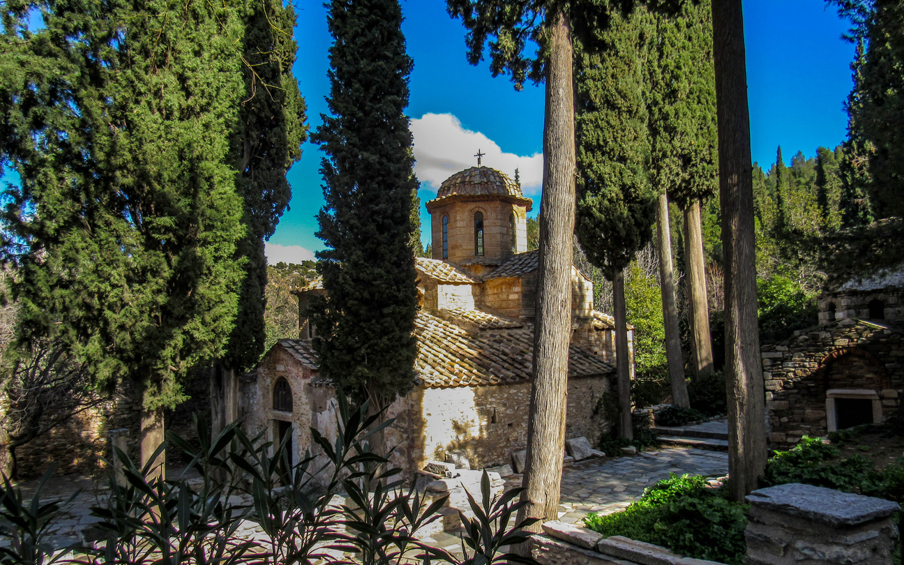 The Kaisariani Monastery beautiful an Eastern Orthodox historical holy place built on the north side of Mount Hymettus in sunny day with clear blue sky, near Athens, Greece