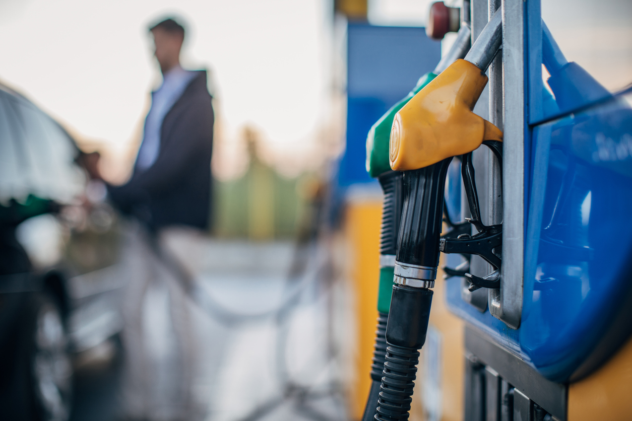 One man, pouring gasoline in his car at the gas station.