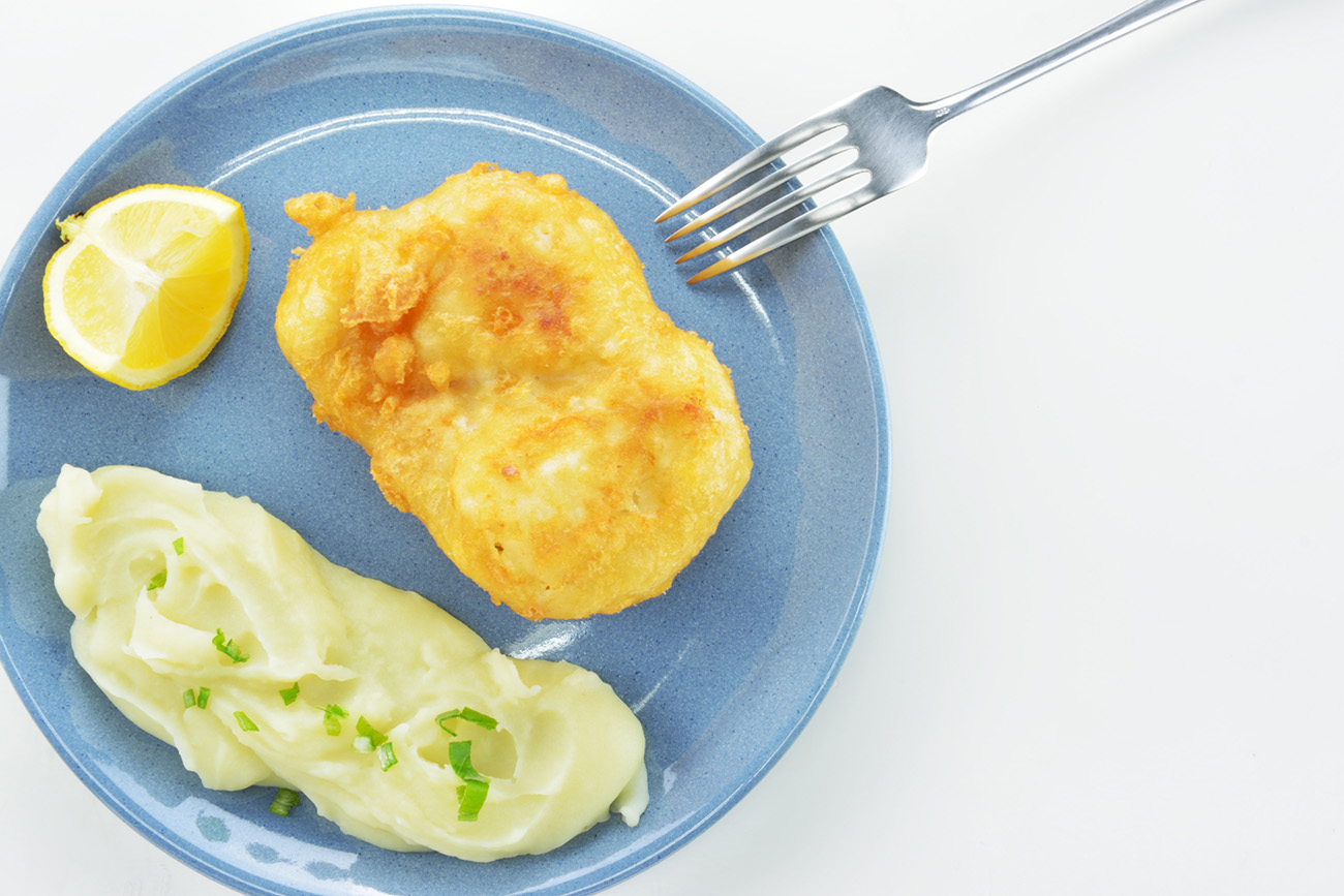 Traditional Greek dish of bread crumbed cod fish  and garlic dip, known as skordalia on white background
