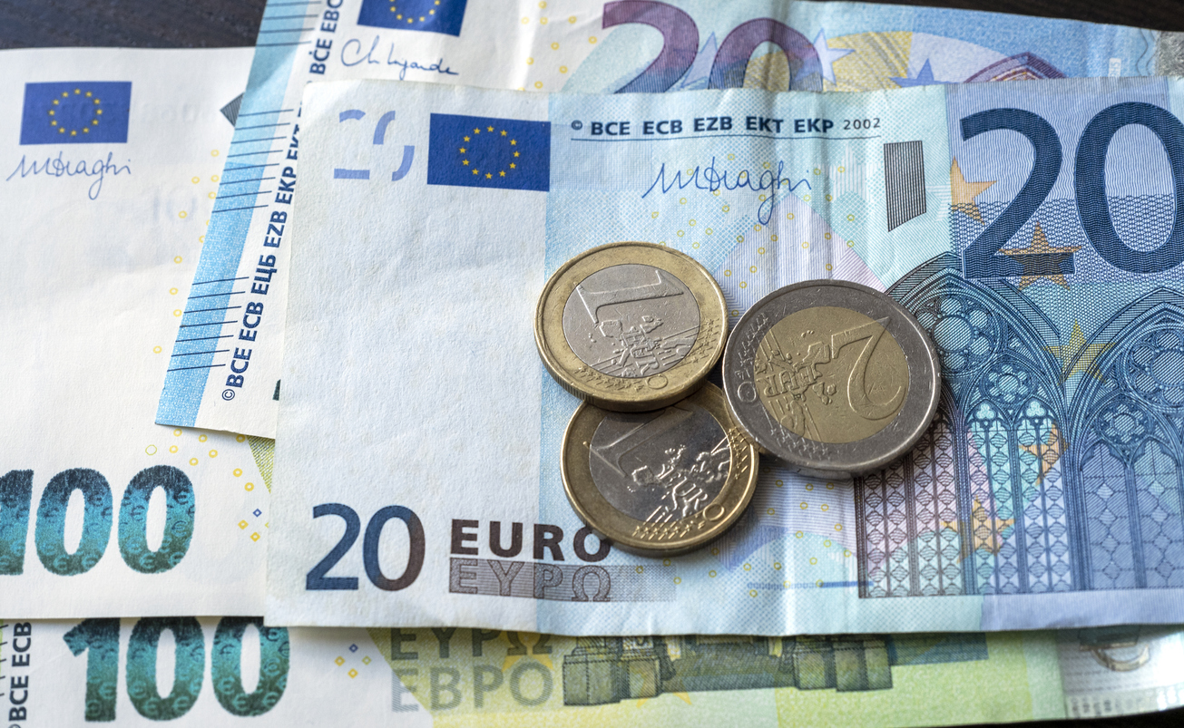 Paper European currency with coins on a table, top view, concept picture
