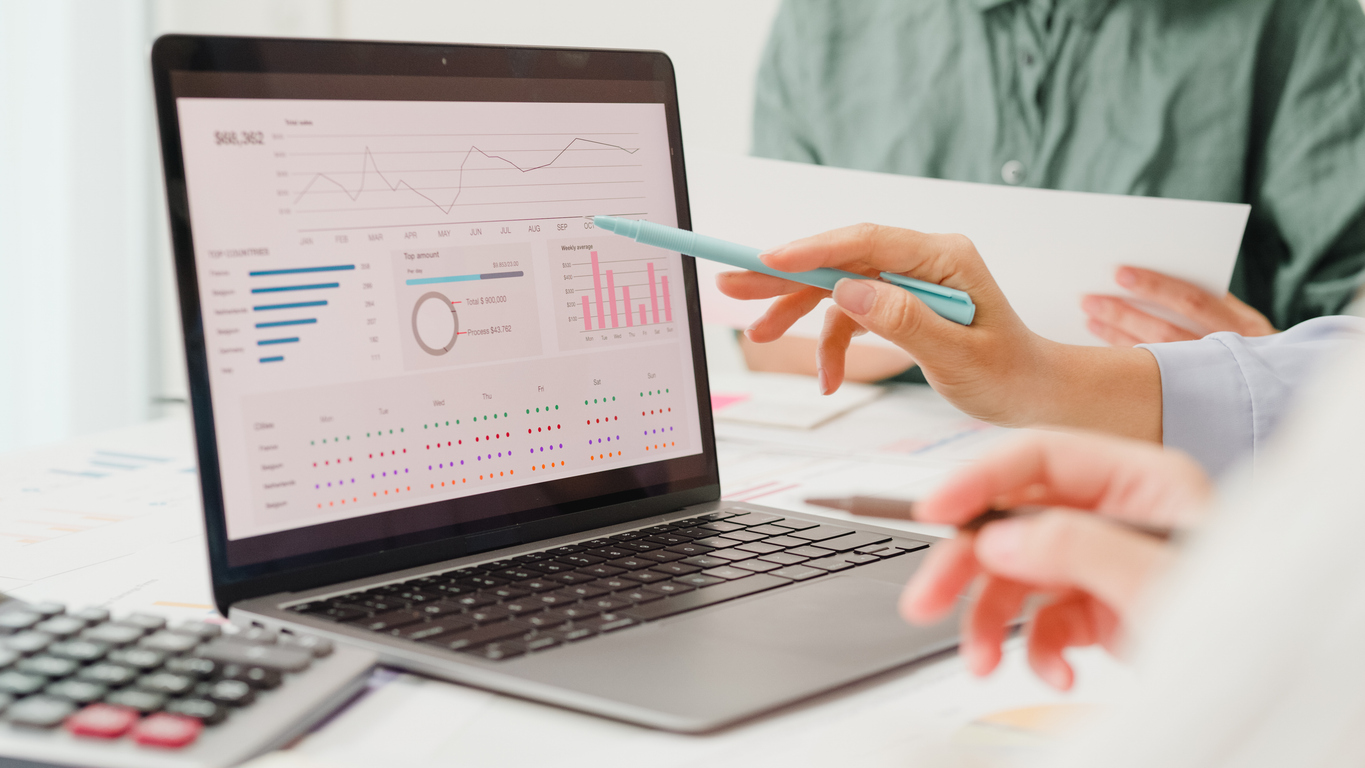 Closeup group of Asian business people meeting discuss project plan and financial results in office. Marketing strategy analysis, stock market trading, financial consultant concept.