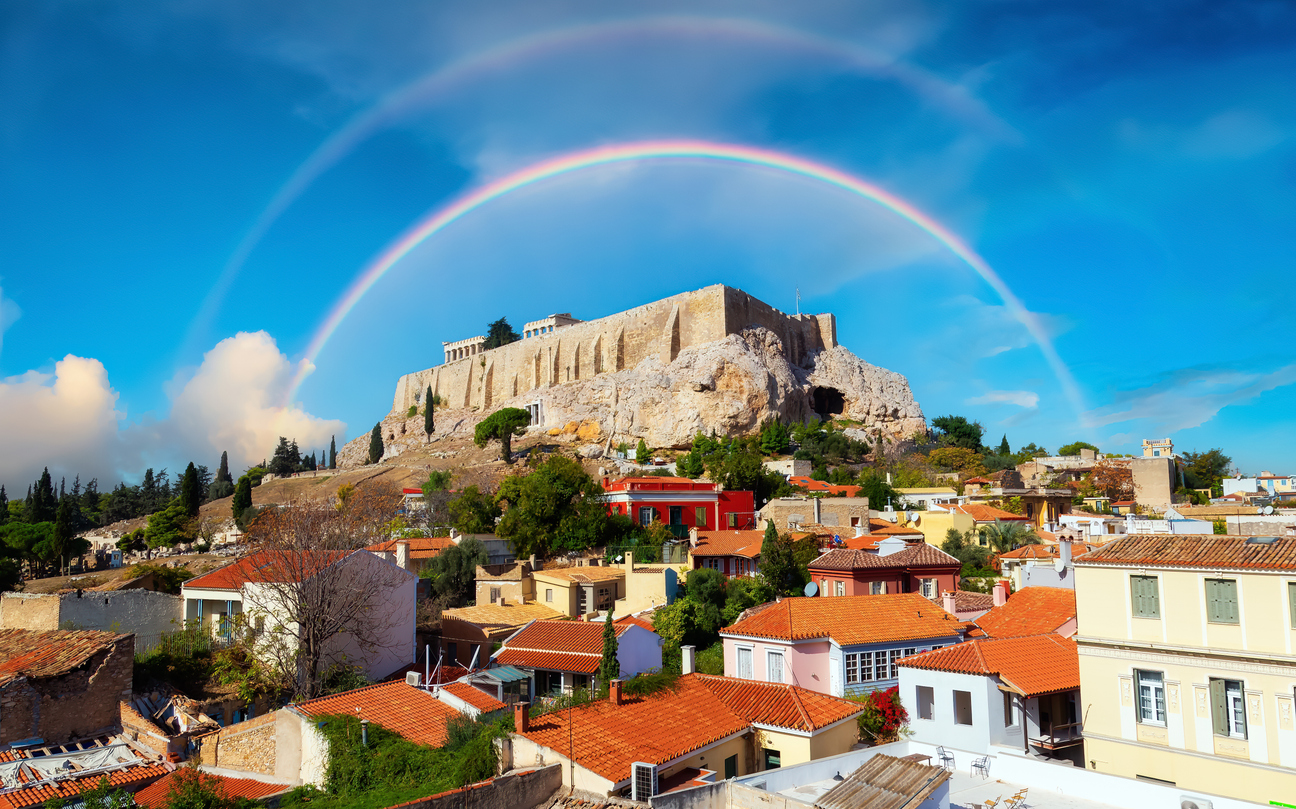 Acropolis and Cityscape in a Historic City with Mountains in Background. Areopagus Hill, Athens, Greece. Sky with Rainbow Art Render.
