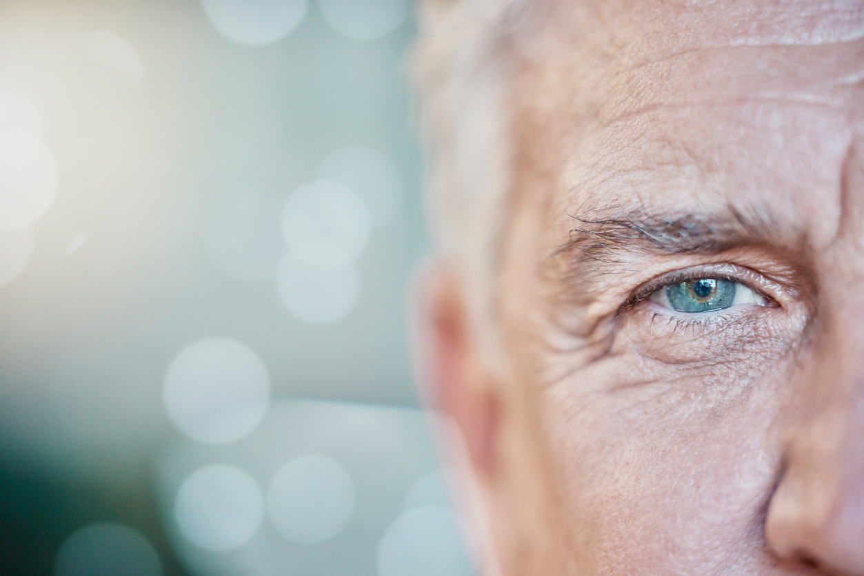 Retina, vision and mockup with blue eye of old man for focus, optometry and healthcare. Iris, human and awareness with senior male and pupil for sight, natural and ophthalmology in bokeh  background