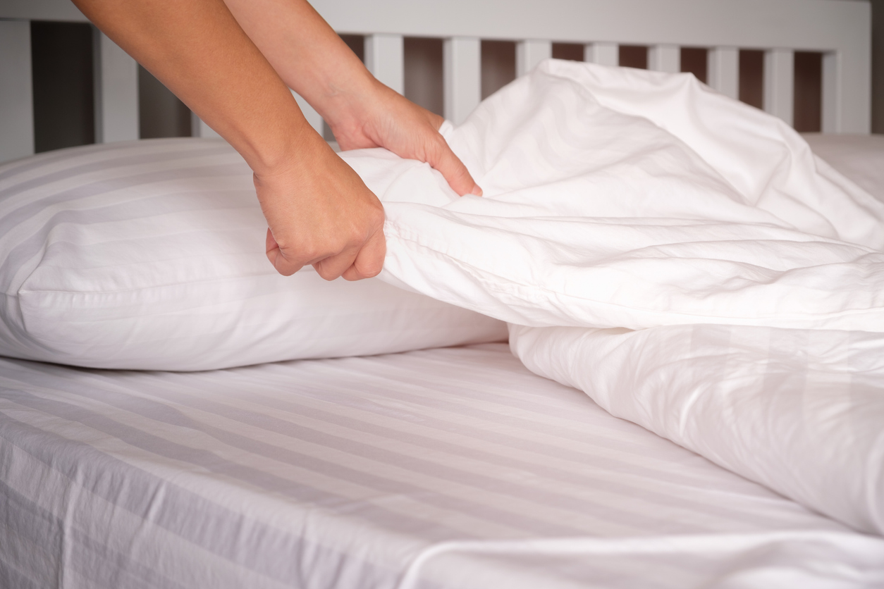 The hands of housewives who are changing sheets in hotels.