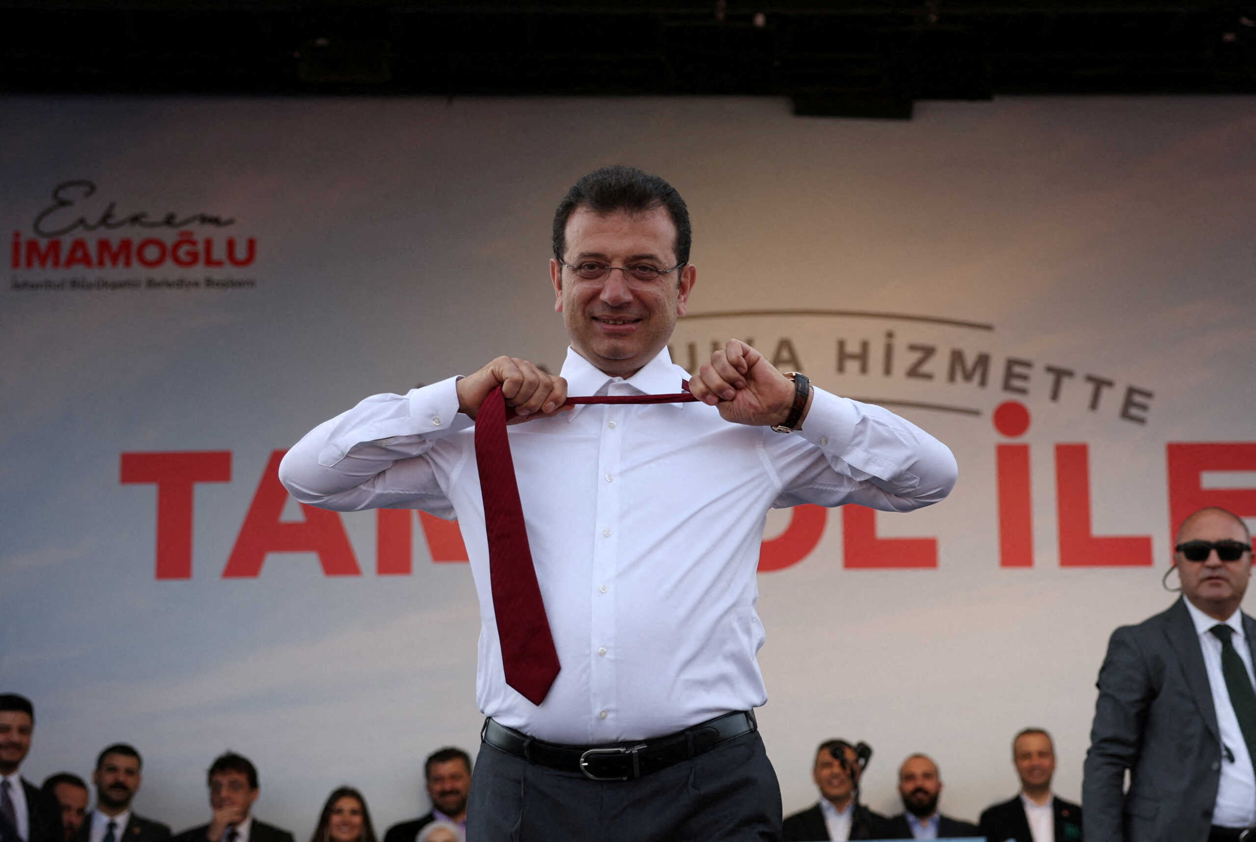 Istanbul Mayor Ekrem Imamoglu, mayoral candidate of the main opposition Republican People's Party (CHP), takes off his tie during a rally ahead of the local elections in Istanbul, Turkey March 30, 2024. REUTERS
