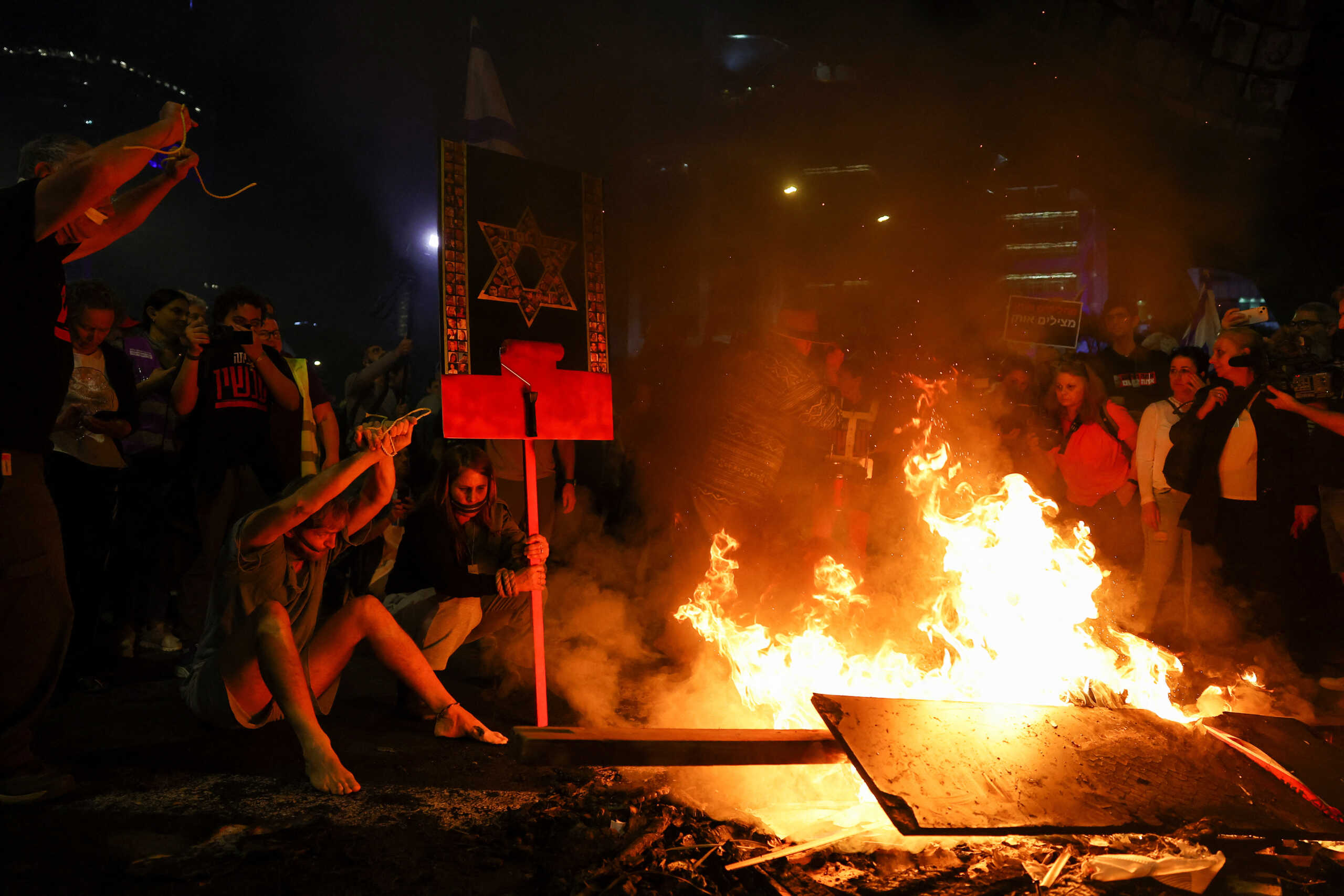 Fire burns as people protest against Israeli Prime Minister Benjamin Netanyahu's government and call for the release of hostages kidnapped in the deadly October 7 attack on Israel by the Palestinian Islamist group Hamas from Gaza, in Tel Aviv, Israel March 30, 2024. REUTERS