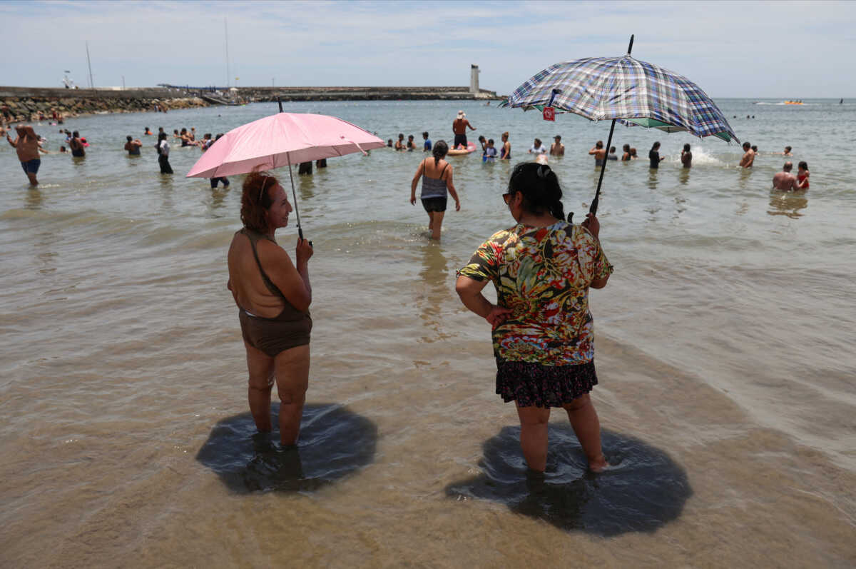 Bathers enjoy a summer day due to the high temperatures at Agua Dulce beach in the Chorrillos district, Lima, Peru, February 24, 2024. REUTERS
