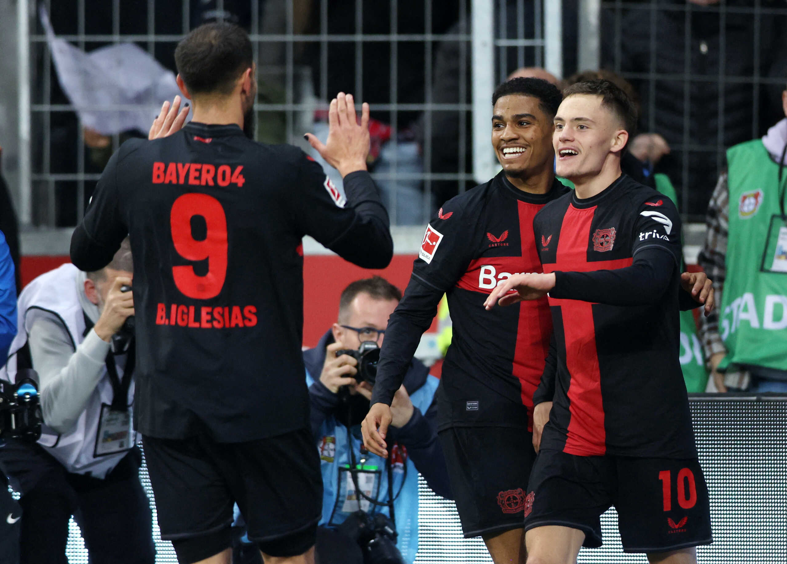 Soccer Football - Bundesliga - Bayer Leverkusen v VfL Wolfsburg - BayArena, Leverkusen, Germany - March 10, 2024 Bayer Leverkusen's Florian Wirtz celebrates scoring their second goal with with Borja Iglesias and Amine Adli REUTERS